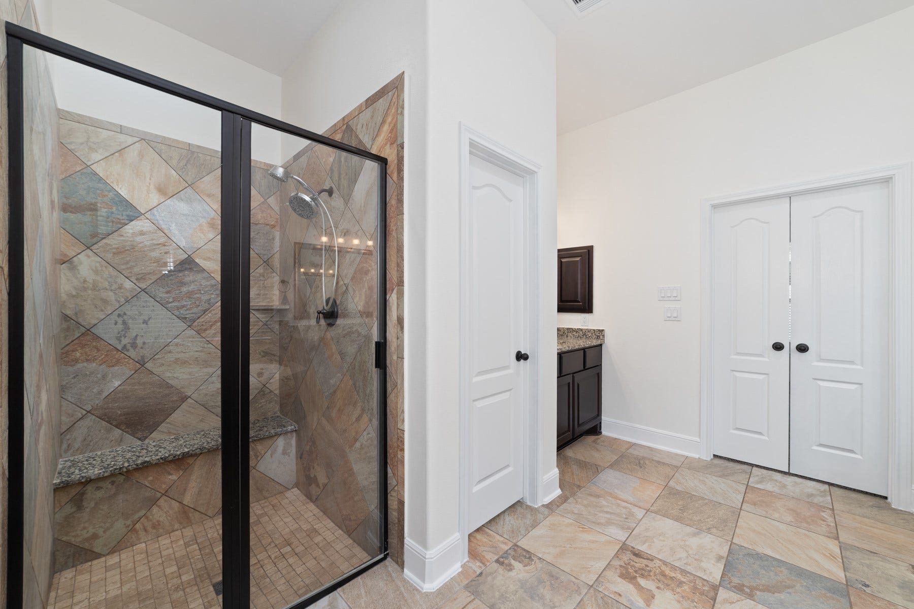 11103 Dowbeck Avenue, Richmond, TX 77407 This modern bathroom features a tiled walk-in shower with glass doors.
