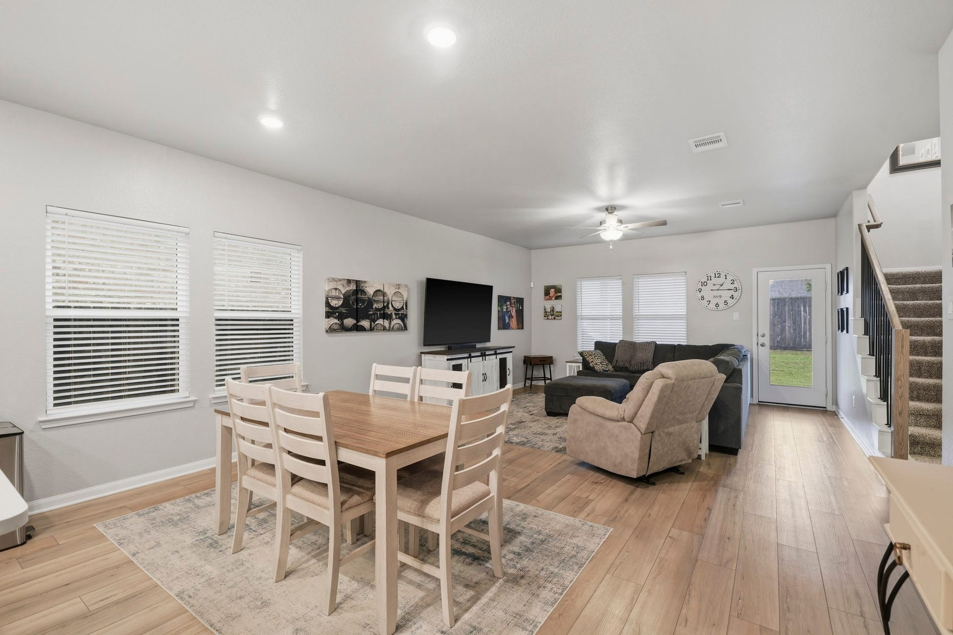Spacious open-concept living and dining area with modern finishes, abundant natural light, and easy access to the backyard.