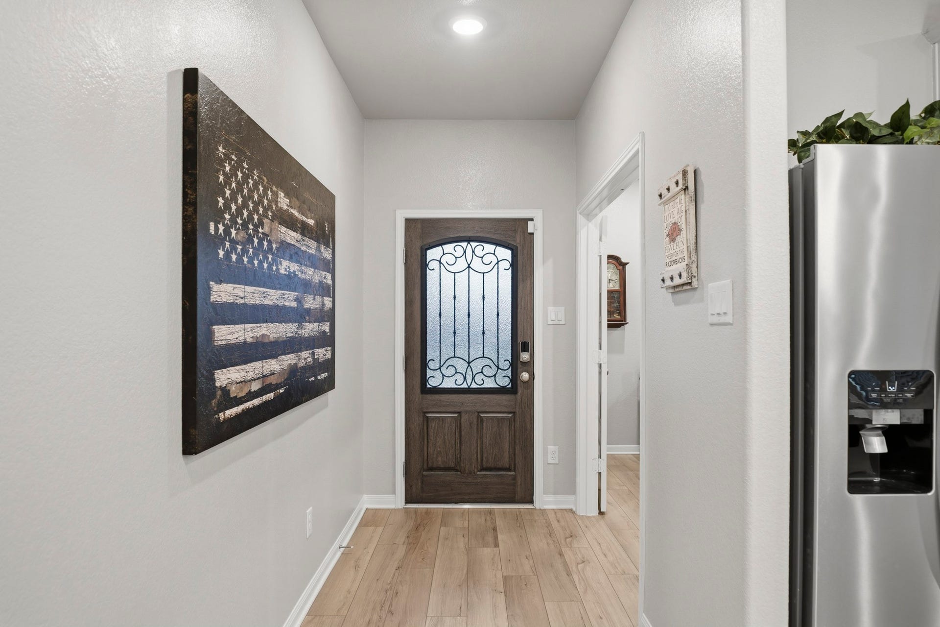 Charming entryway with a decorative glass front door.