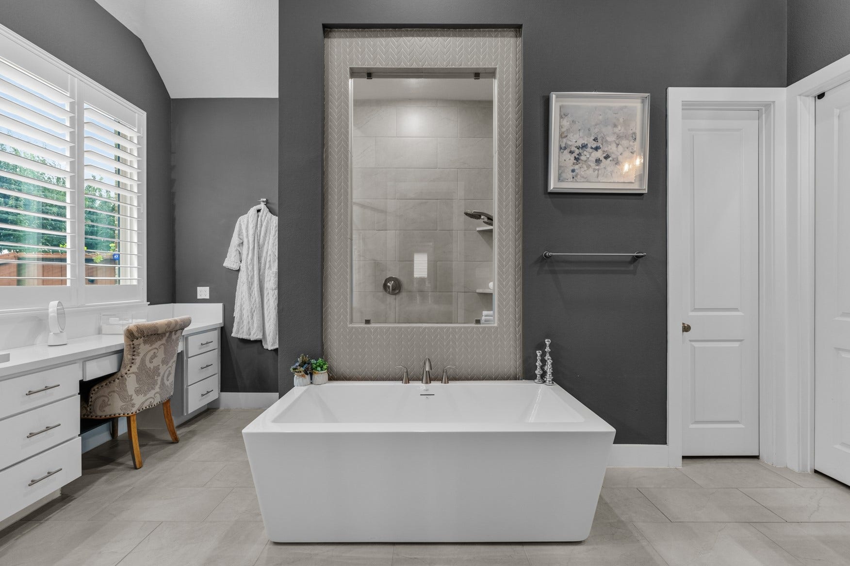 2214 Almond Creek Lane, Fulshear, TX 77423 A luuxrious spa-like bathroom with upscale design awaits. The large soaking tub is highlighted by the window to the walk-in shower, surrounded by timeless herringbone tilework.