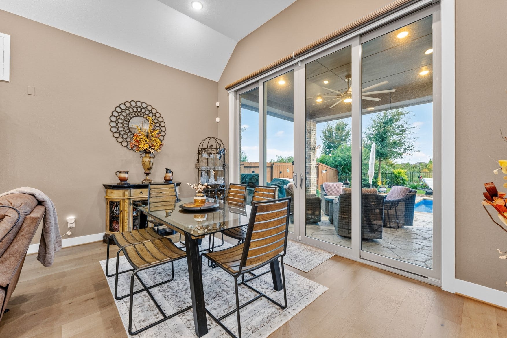 2214 Almond Creek Lane, Fulshear, TX 77423 Open the tall patio doors to extend your living space outdoors. An electric roller shade has been installed for extra privacy when needed.