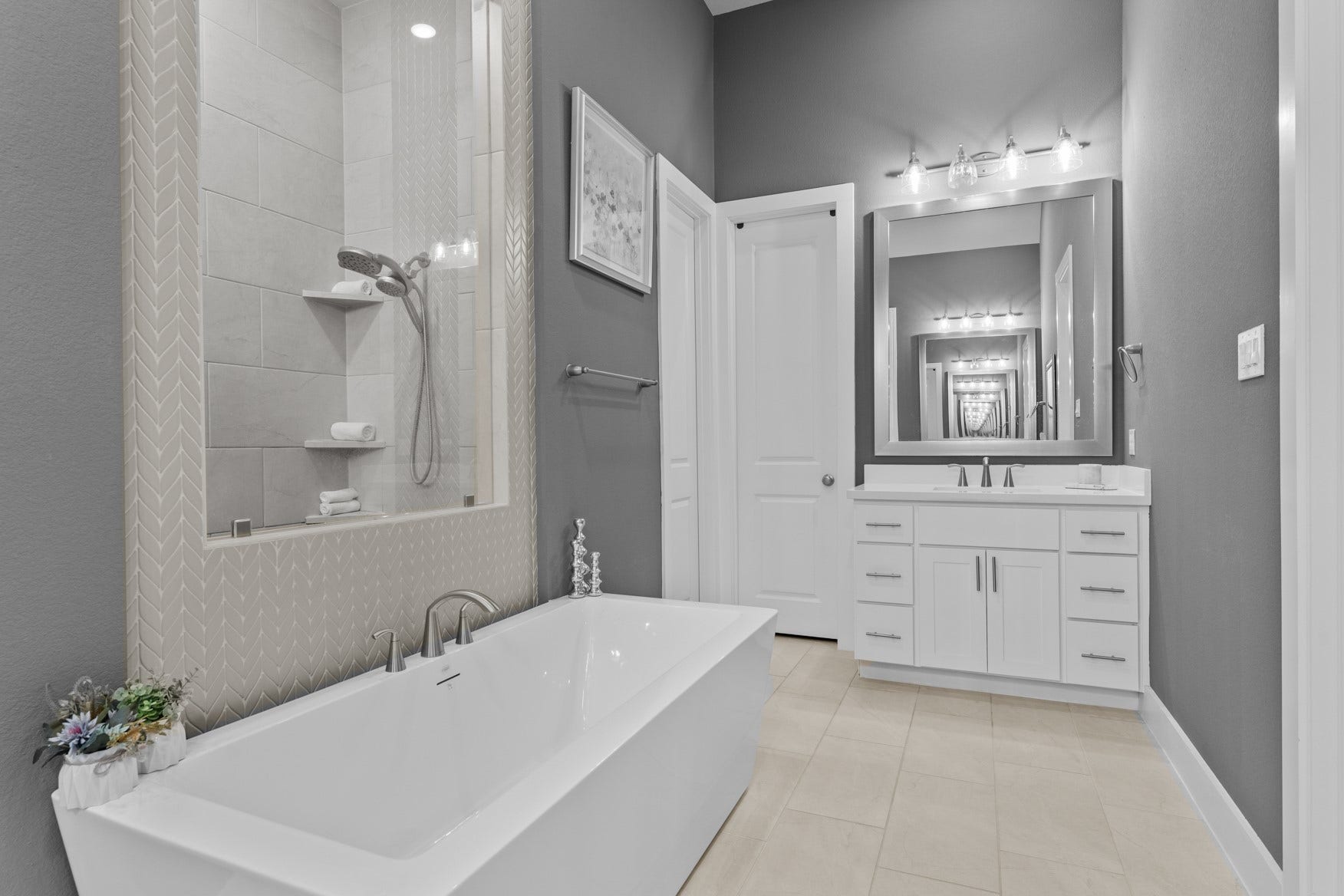 2214 Almond Creek Lane, Fulshear, TX 77423 Second sink/vanity with framed mirror. The door to the left leads to a large walk-in closet.