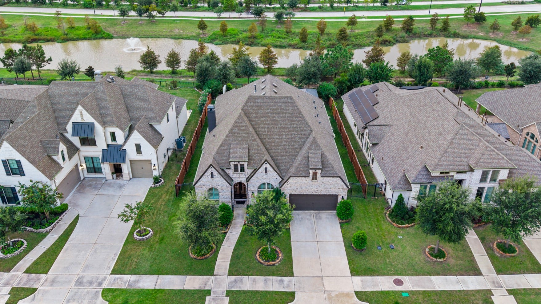 2214 Almond Creek Lane, Fulshear, TX 77423 This home sits on a private oversized lot with no back neighbors. Enjoy a view of the wide green space and community lake from your backyard!