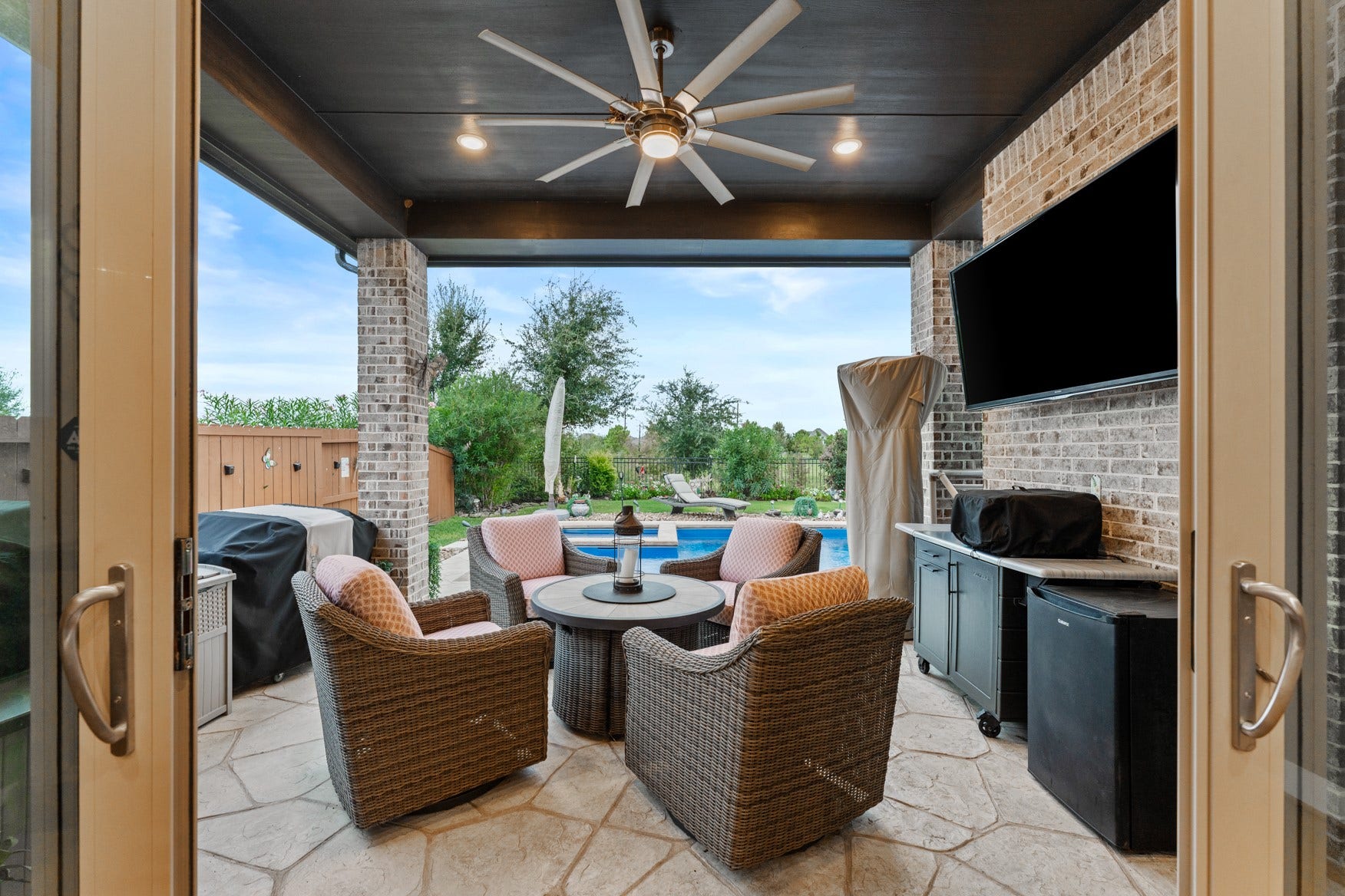 2214 Almond Creek Lane, Fulshear, TX 77423 Walk through the patio doors onto your covered patio that is the perfect spot to relax by the pool, watch the game, and enjoy outdoor grilling.