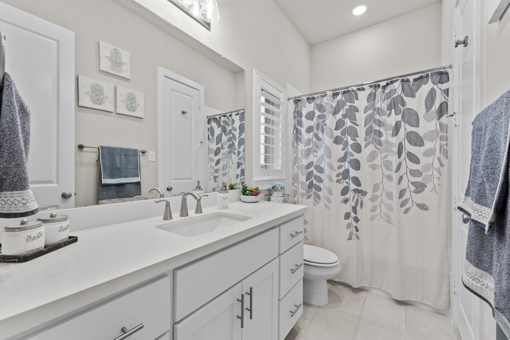 2214 Almond Creek Lane, Fulshear, TX 77423 A perfect bathroom for the guest suite - long counter, plenty of storage, and a tub/shower combo.