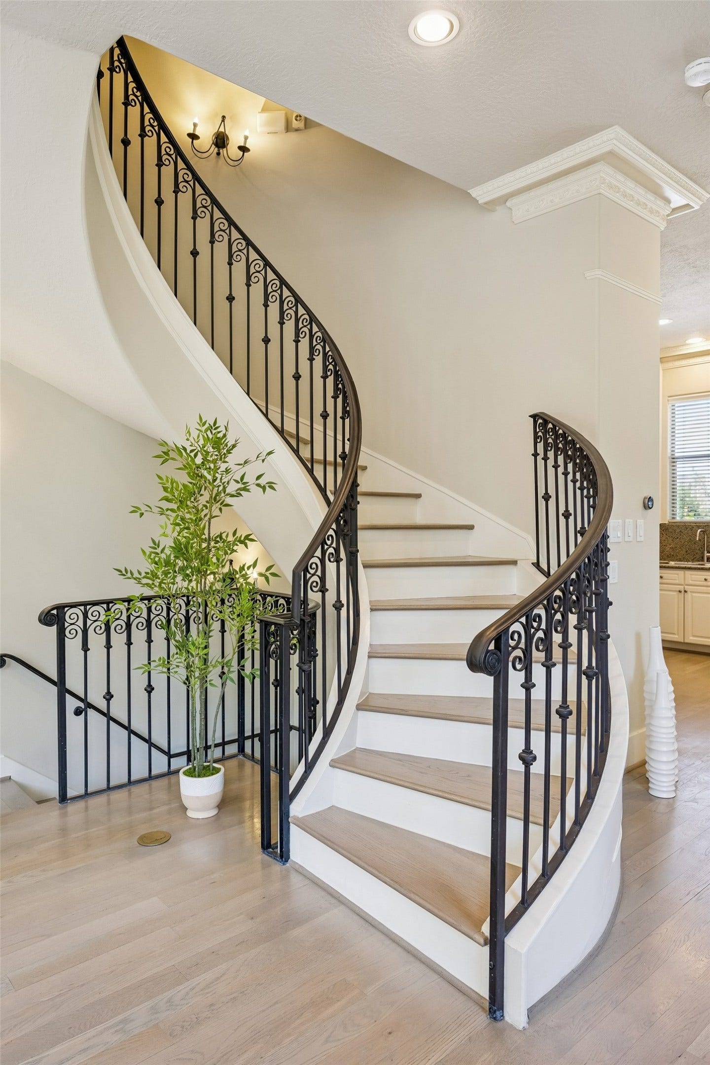 1477 Missouri Street, Houston, TX 77006 Beautiful curved staircase with iron banister creates an architectural focal point in the main living area.