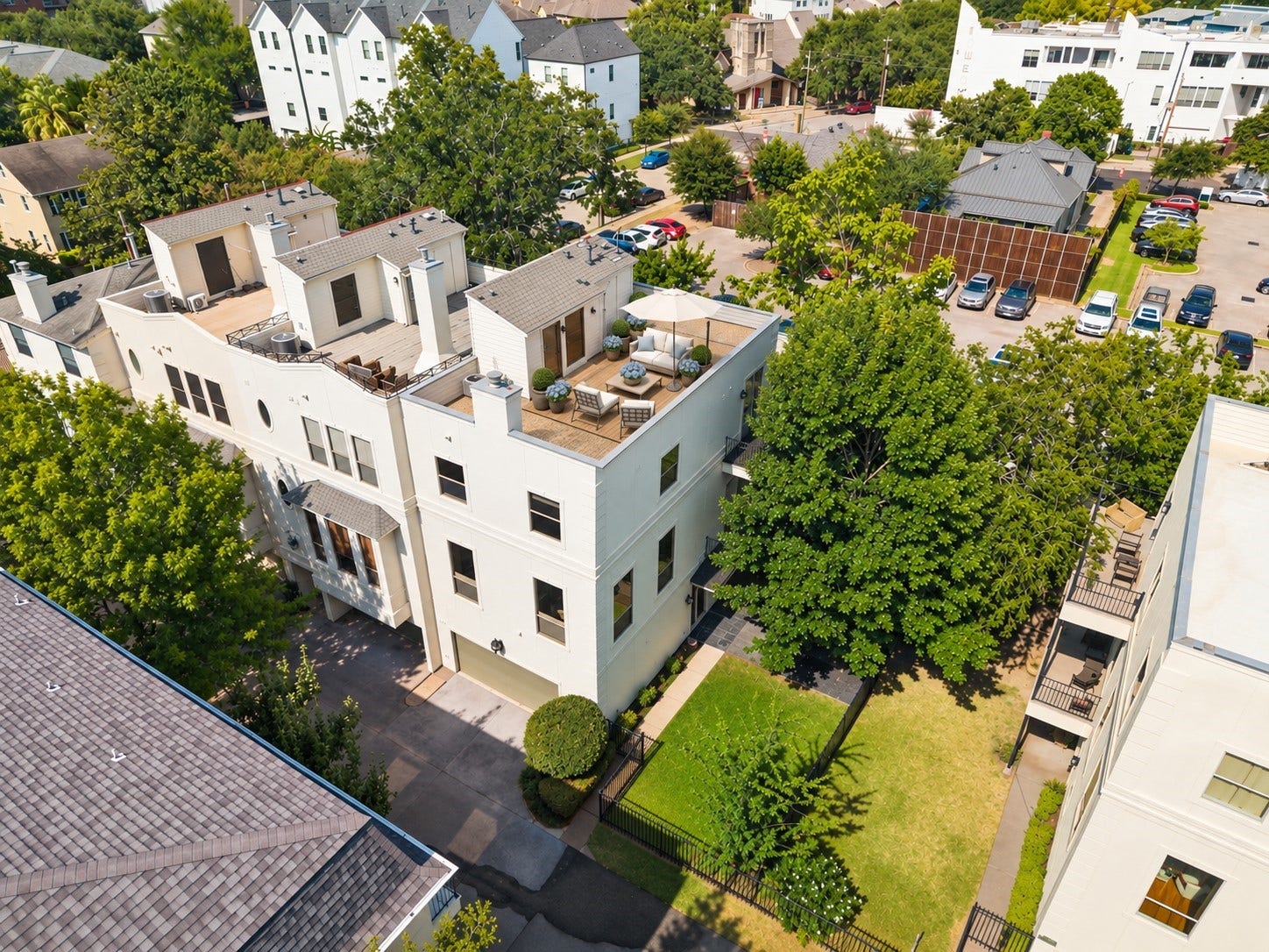 1477 Missouri Street, Houston, TX 77006 Aerial view highlights the end-unit setting, rare private fenced grass yard and expansive rooftop terrace, offering multiple outdoor spaces in the heart of Hyde Park. *Image has been virtually staged.