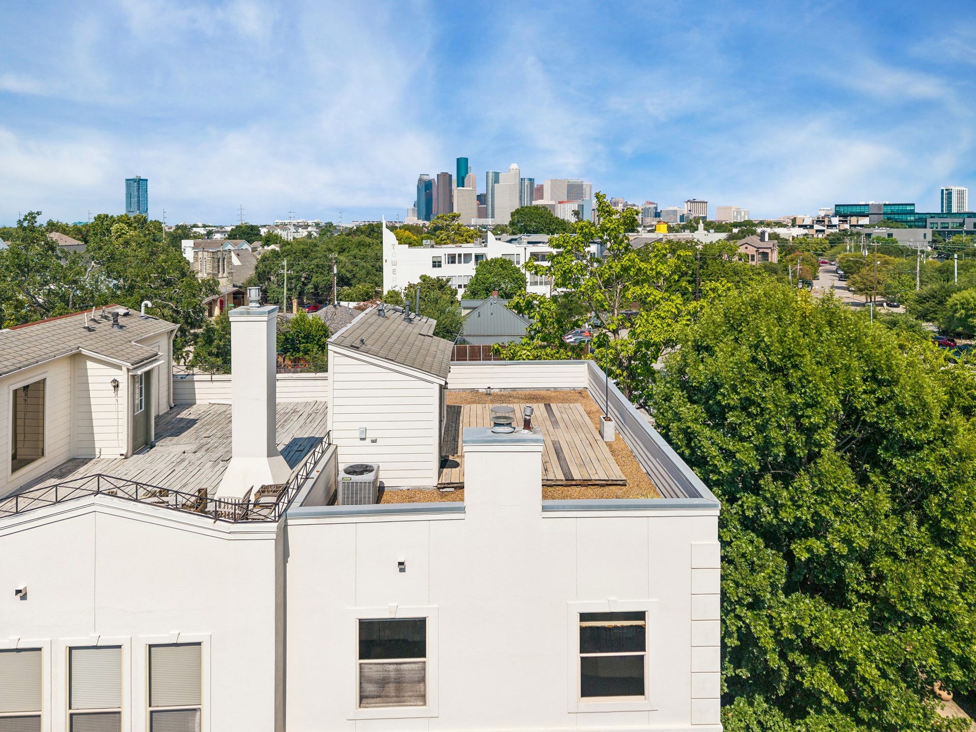 1477 Missouri Street, Houston, TX 77006 Elevated perspective showcasing the homes rooftop terrace and proximity to Downtown Houston.