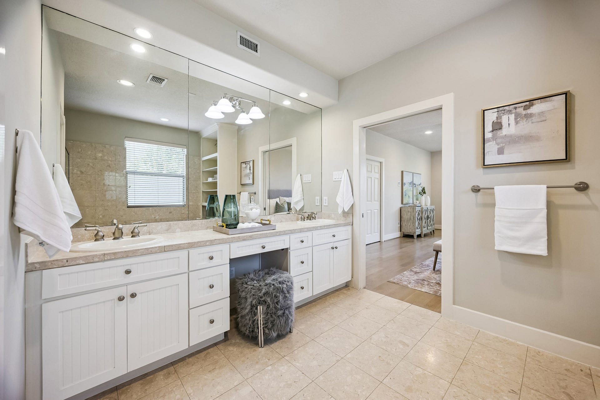 1477 Missouri Street, Houston, TX 77006 Primary bath with long vanity, abundant cabinetry and large wall mirror.