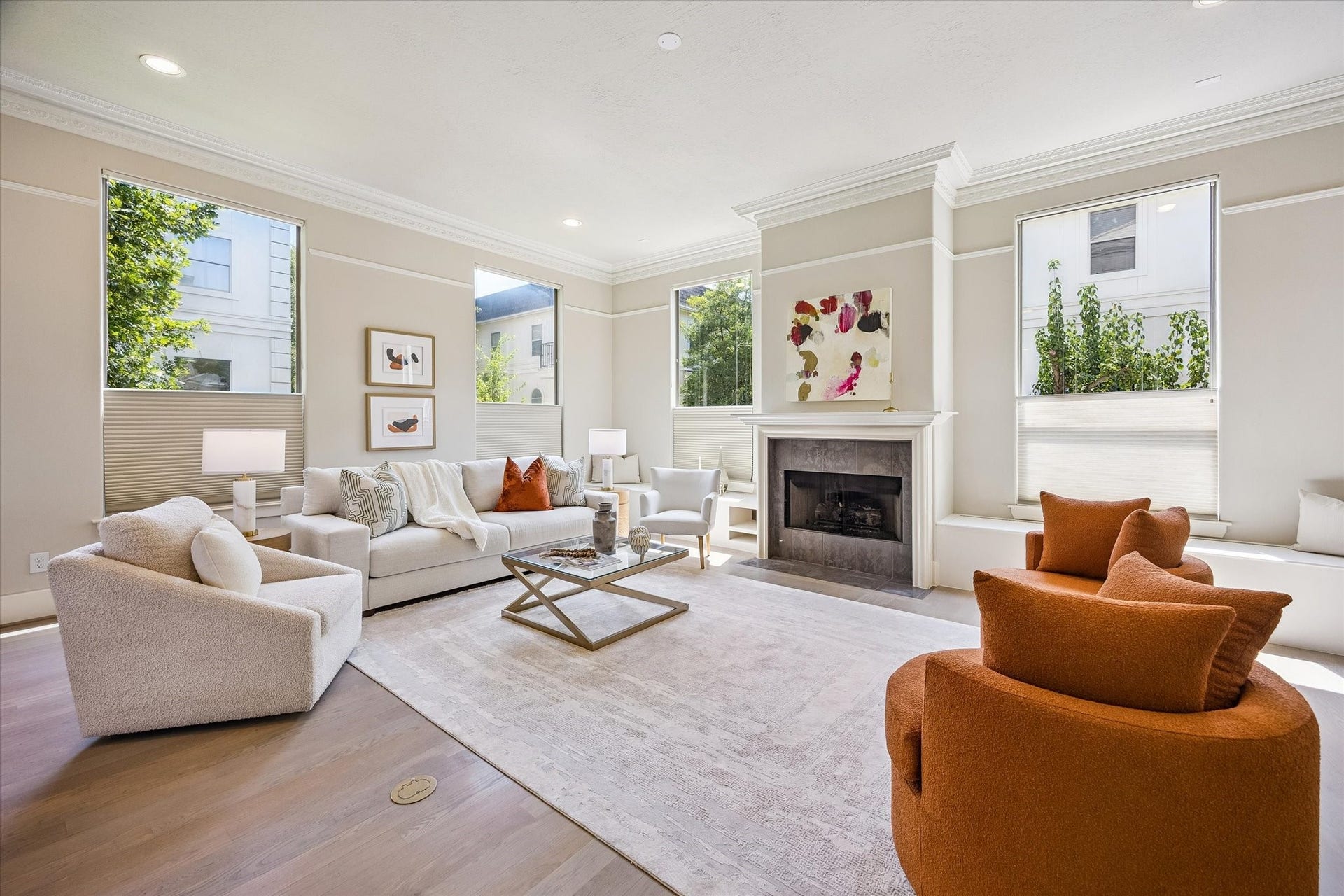 1477 Missouri Street, Houston, TX 77006 Inviting living area centered around a fireplace, flanked by built-in storage bench seating and framed by refined millwork and expansive windows.