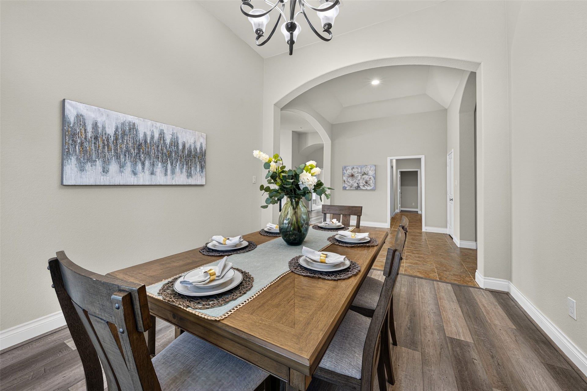Elegant formal dining room framed by wide windows with classic plantation shutters.