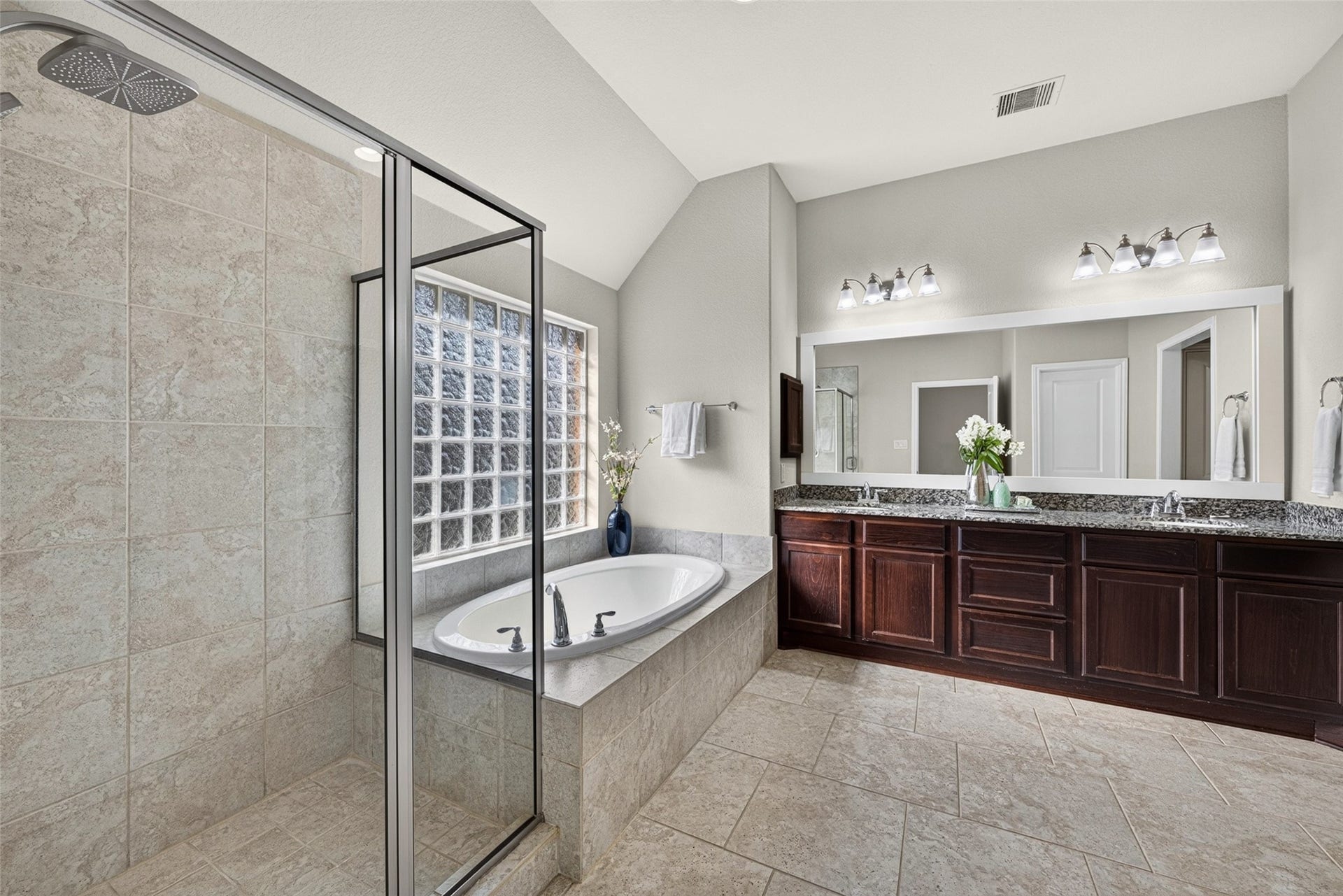 Relaxing primary bath featuring a deep soaking tub and separate shower for spa-like downtime at home.