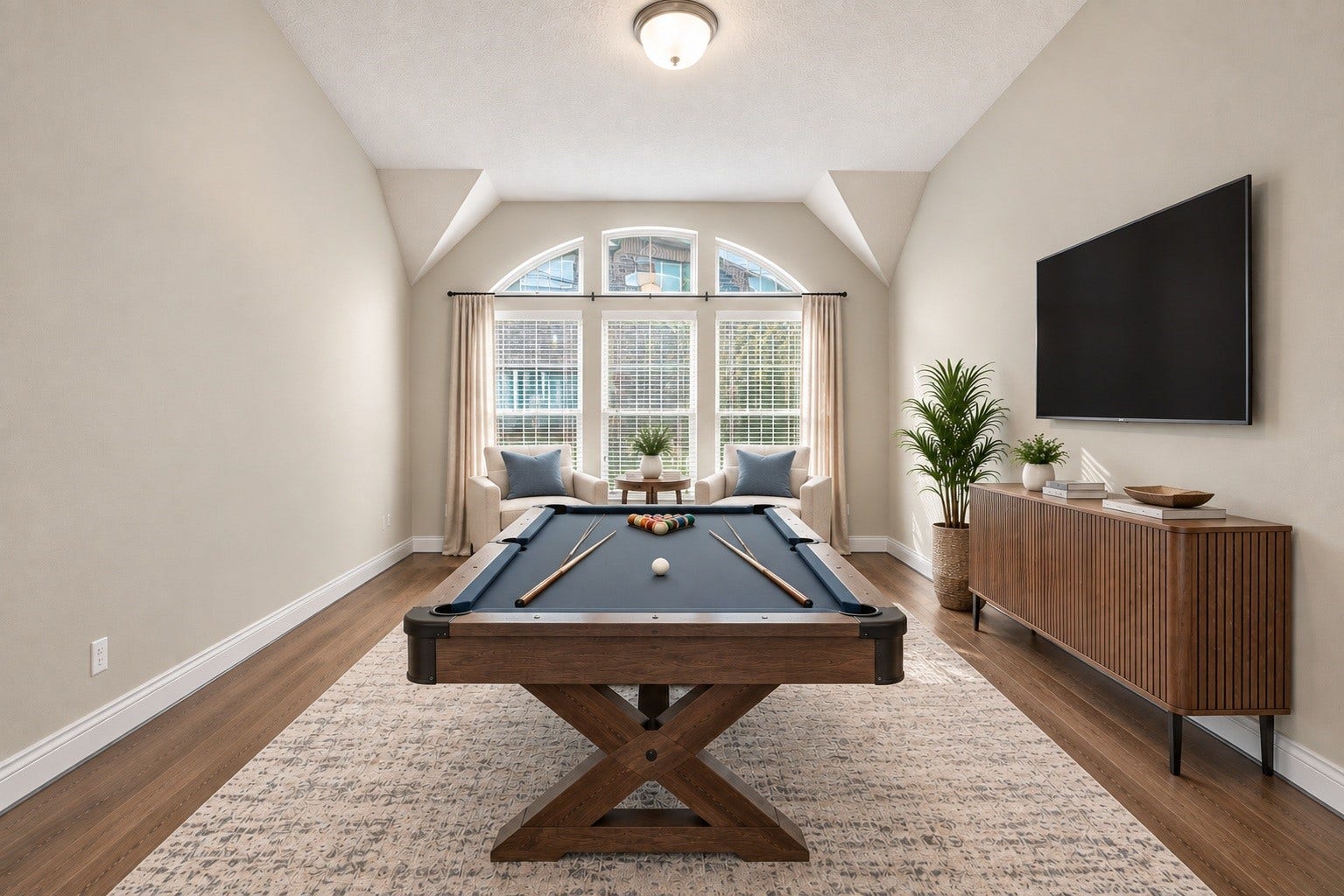 Versatile game room filled with possibilitiesideal for board games, playtime, or a family media space. (virtual staged)