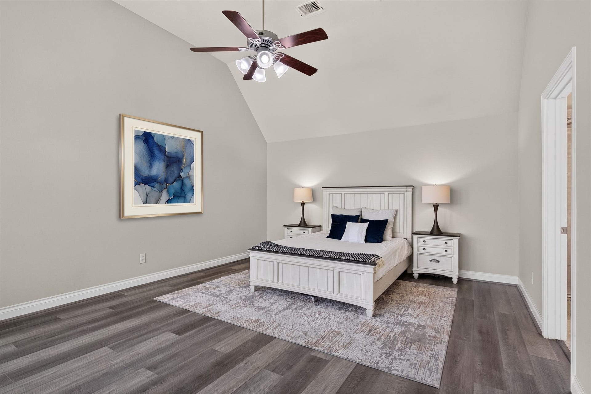 Peaceful primary suite offering a quiet escape with wide windows and tranquil views of the backyard.