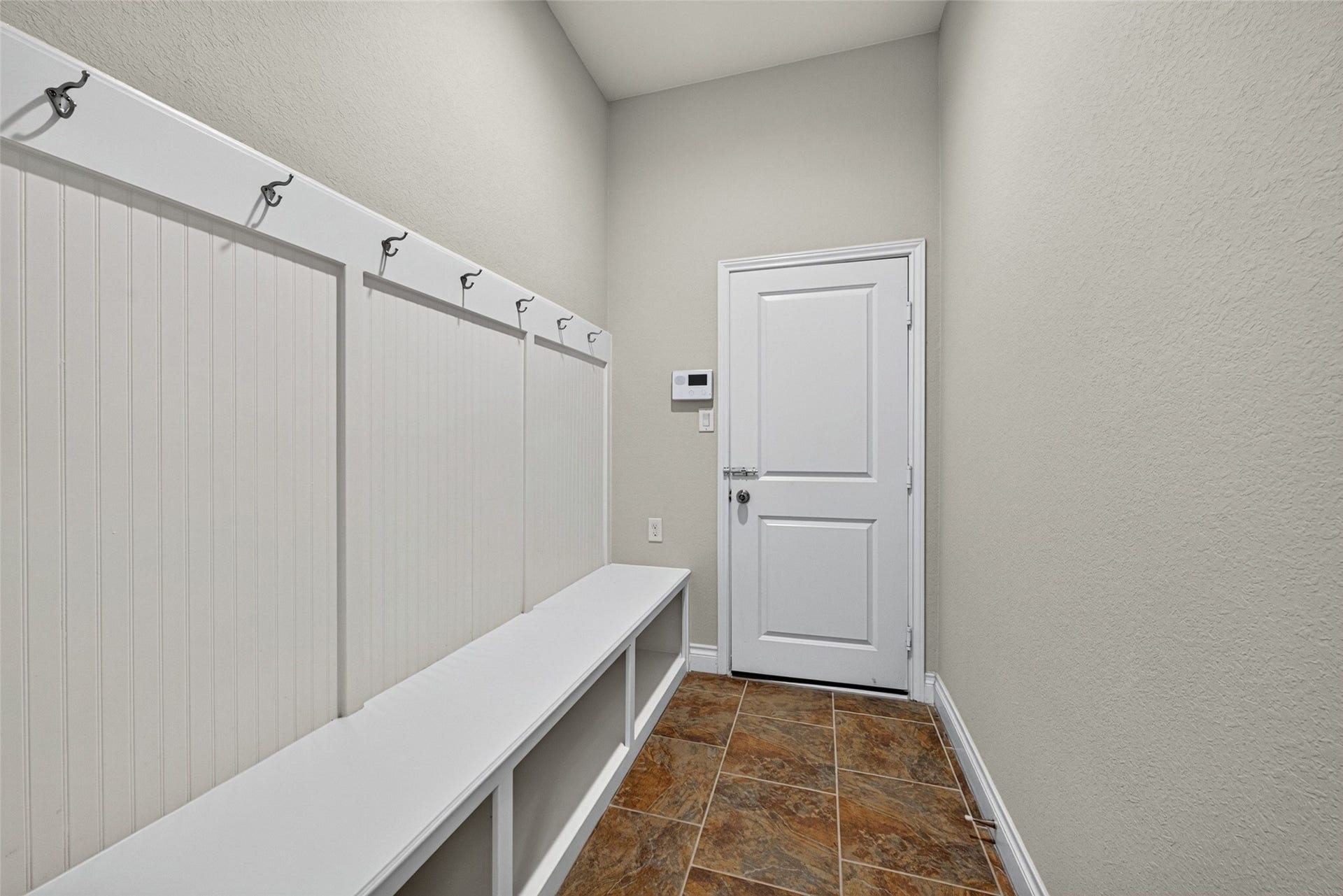 Convenient mudroom space to drop backpacks, shoes, and coats right after coming home.