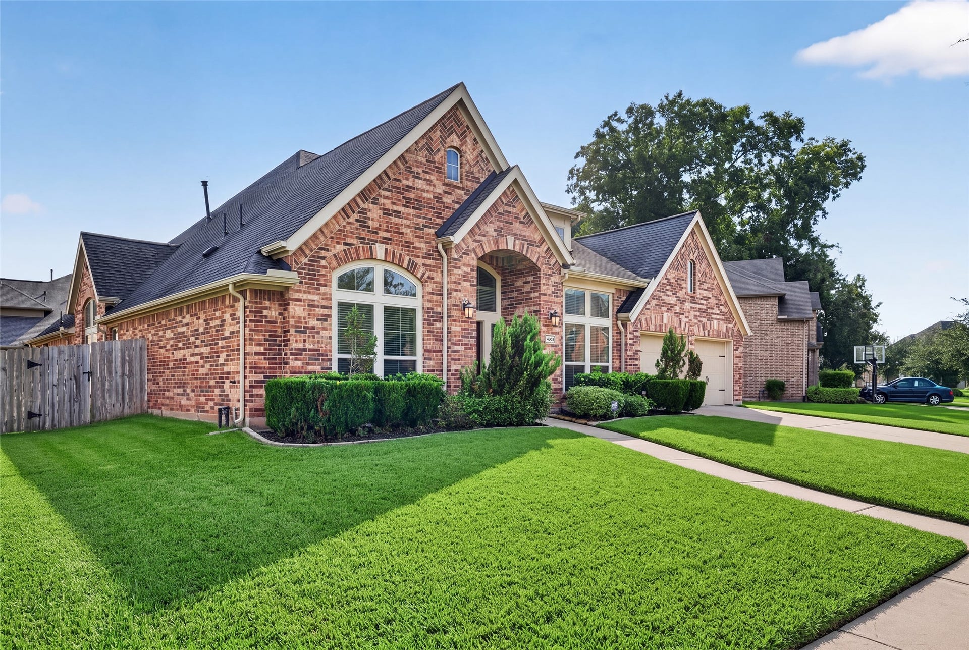 Manicured front lawn and attractive exterior showcasing meticulous care and beautiful architectural detail.