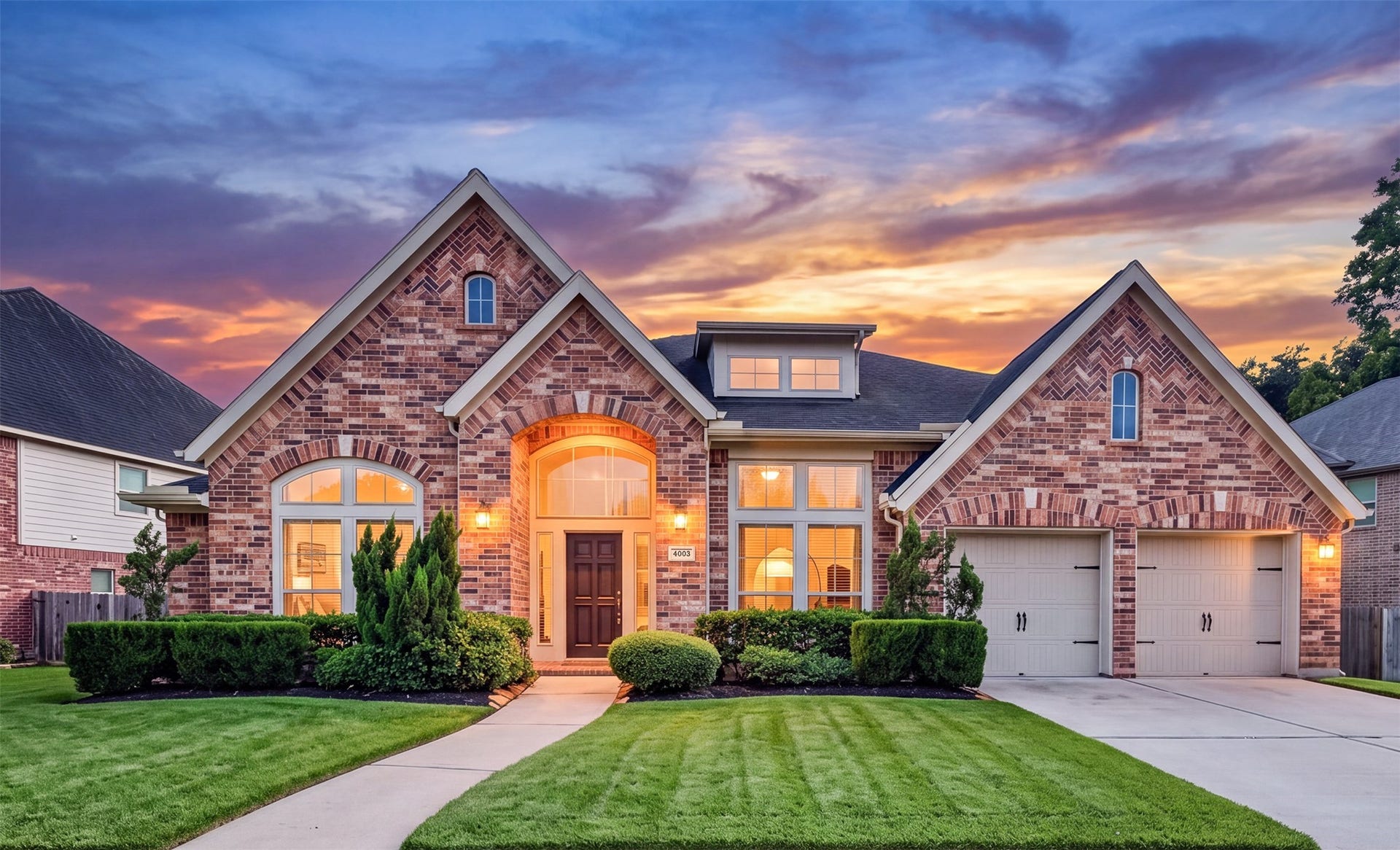 Beautiful 1-story home featuring stunning elevation, charming brick & stone facade, and exceptional curb appeal.