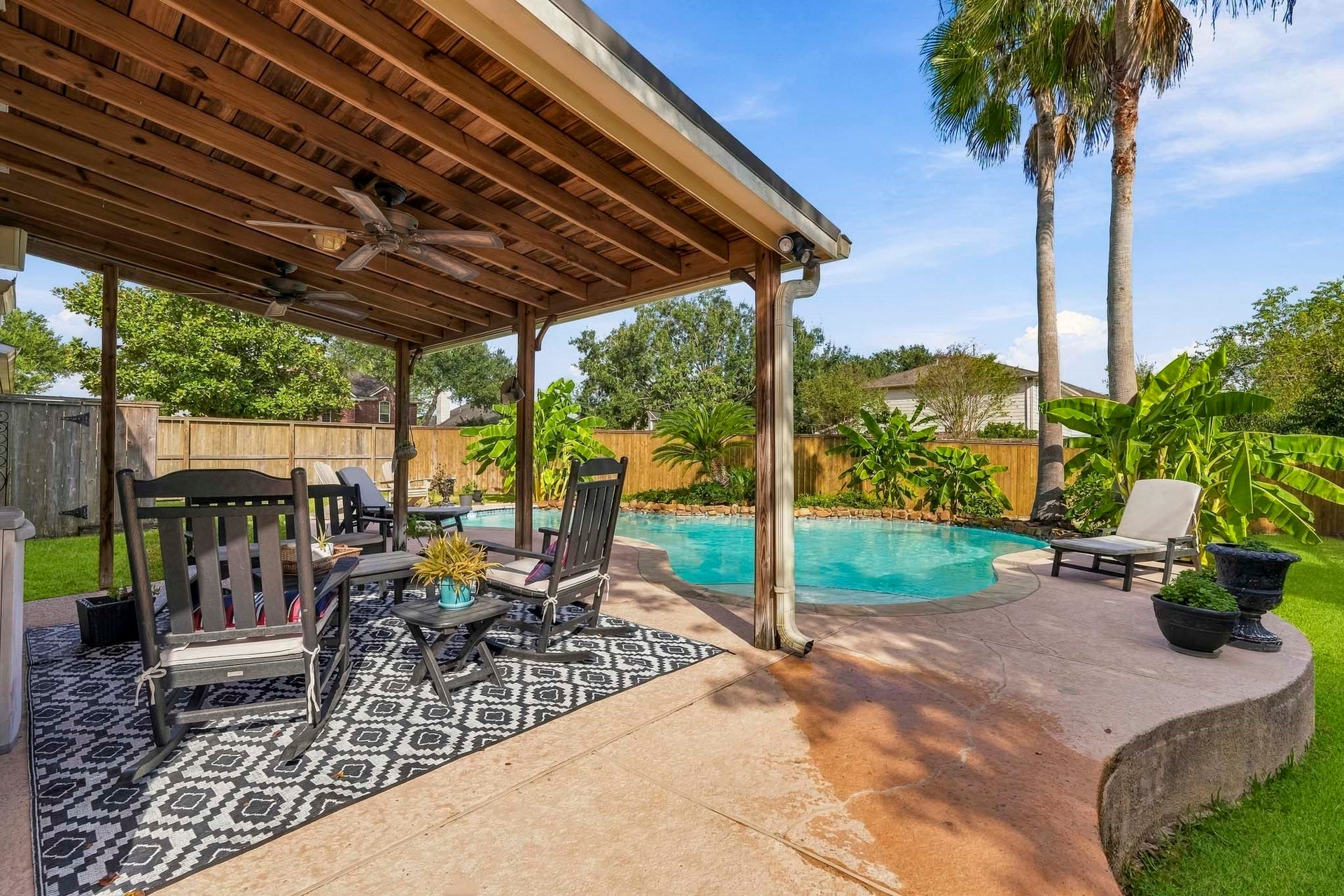 3905 Kimberly Drive, Pearland, TX 77581 The deck leads to the pool and covered patio with fan