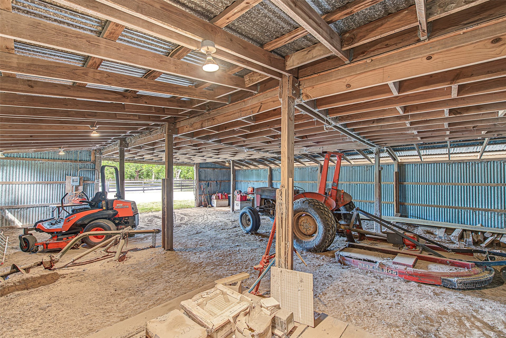 The vast open space accommodates large agricultural equipmentsuch as tractors, zero-turn mowers, and implementswith plenty of room remaining for a dedicated workshop, hay storage, or livestock gear