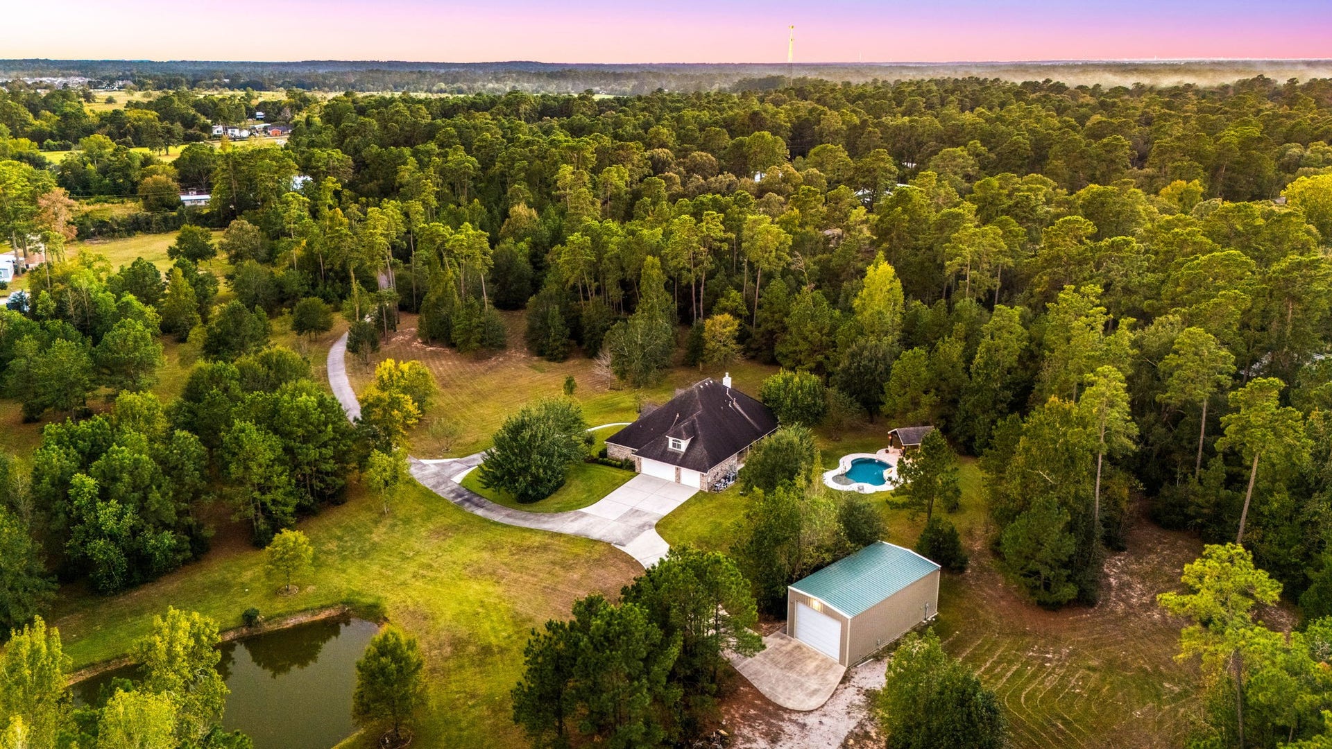 13506 Stagecoach Road, Magnolia, TX 77355 This stunning aerial view showcases the full beauty of the property, lush trees framing expansive green space, a sparkling pool, and a covered outdoor pavilion. The layout offers privacy, tranquility, and a true sense of country living, all within a beautifully maintained setting.