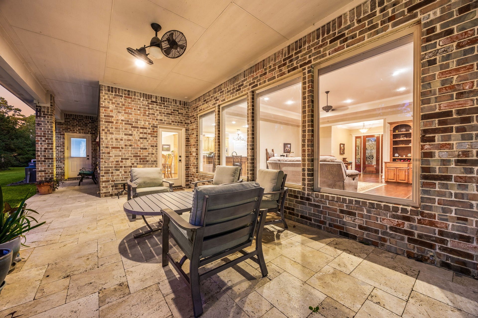 13506 Stagecoach Road, Magnolia, TX 77355 Enjoy peaceful evenings on the covered patio overlooking the serene, tree-lined backyard, perfect for relaxing or entertaining outdoors.