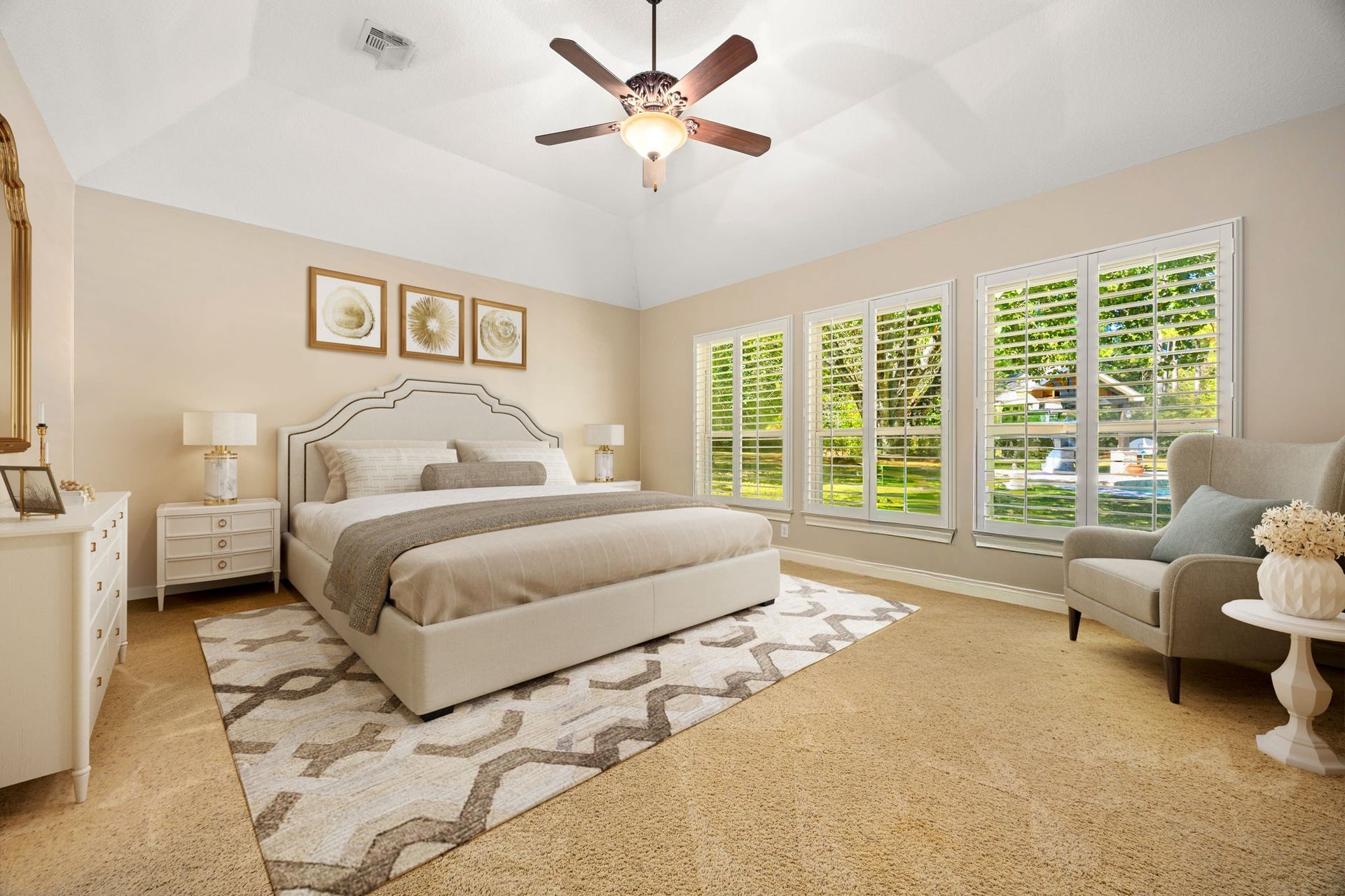 13506 Stagecoach Road, Magnolia, TX 77355 The serene primary suite features a vaulted ceiling, large windows with plantation shutters, and soft natural light that enhances the rooms spacious feel. A peaceful retreat, it offers comfort and privacy with beautiful views of the surrounding landscape.