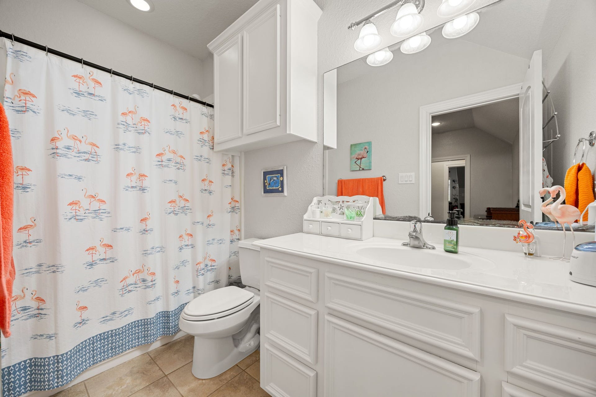 13506 Stagecoach Road, Magnolia, TX 77355 Charming full bath featuring a large vanity with ample storage, bright lighting, and a clean, classic design.