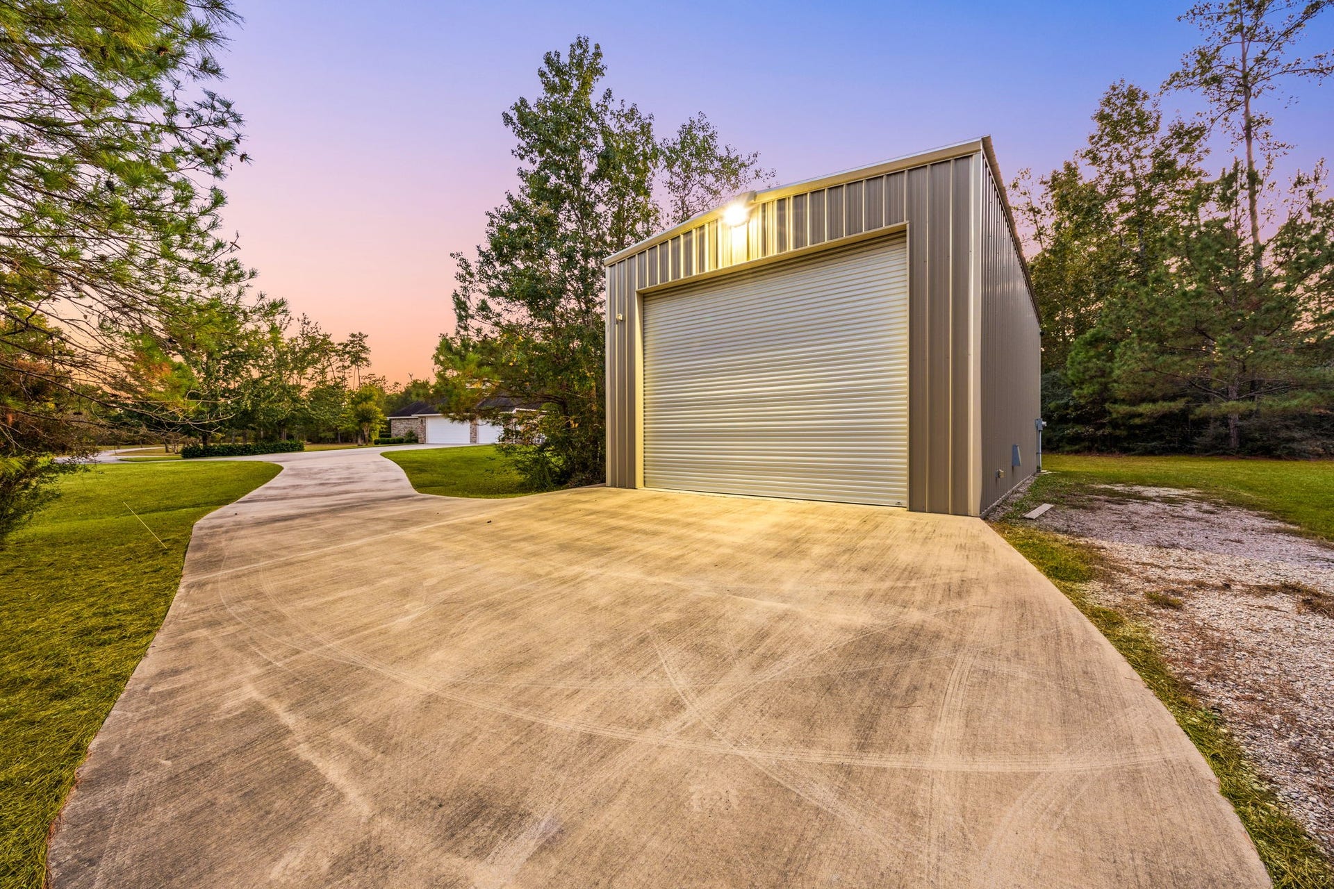 13506 Stagecoach Road, Magnolia, TX 77355 This property includes a spacious detached workshop with a large roll-up door, concrete drive, and ample room for storage, hobbies, or equipment. A versatile addition to the acreage, it offers convenience and functionality just steps from the main home.