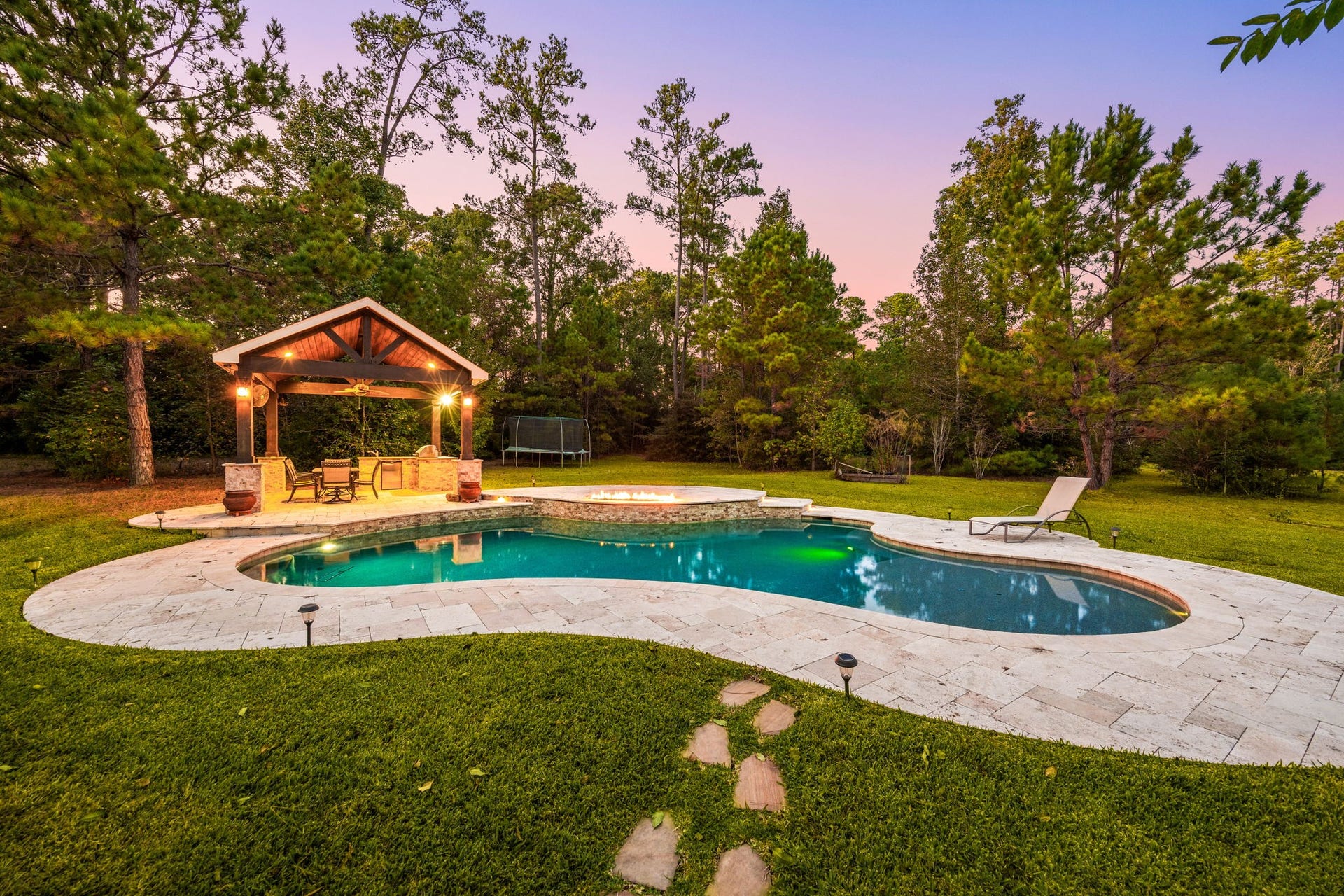 13506 Stagecoach Road, Magnolia, TX 77355 Step into your own backyard oasis featuring a sparkling pool, spacious patio, and charming pavilion, ideal for summer gatherings or relaxing evenings surrounded by nature.
