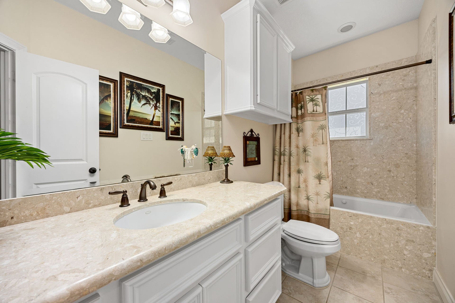 13506 Stagecoach Road, Magnolia, TX 77355 This elegant secondary bath features a granite vanity, custom cabinetry, and a beautifully tiled tub/shower combo, perfectly blending functionality with timeless style.