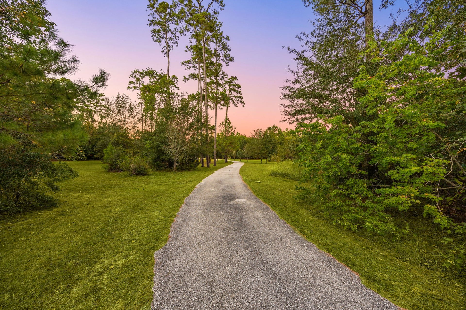 13506 Stagecoach Road, Magnolia, TX 77355 A long, winding driveway leads you through a canopy of mature trees, setting a serene tone before you even reach the home. This private approach perfectly captures the peaceful charm of country living while maintaining a refined, welcoming feel.