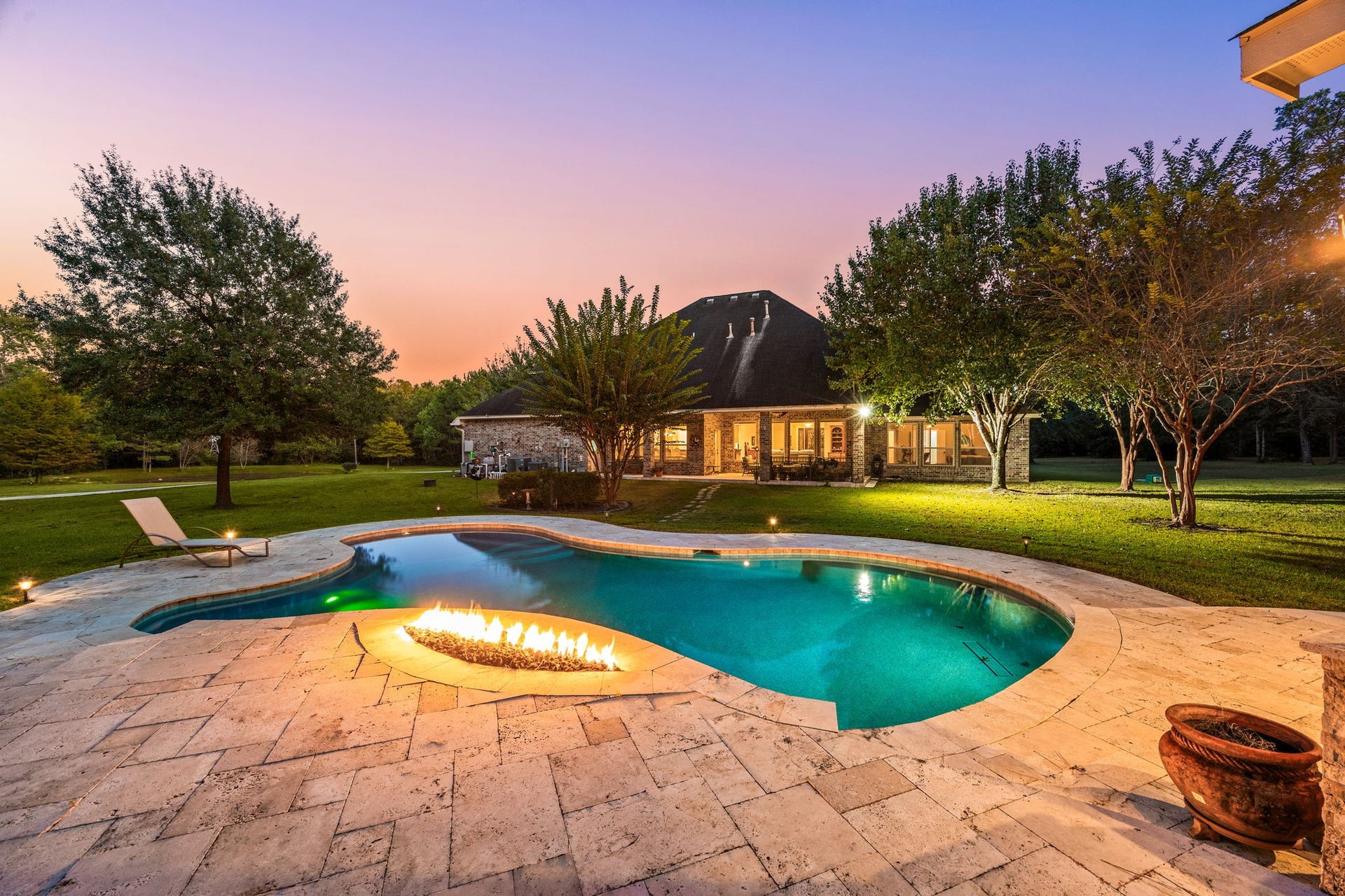 13506 Stagecoach Road, Magnolia, TX 77355 Experience resort-style living in this stunning backyard featuring a sparkling pool, expansive patio, and lush landscaping. Unwind under the evening sky or host memorable gatherings surrounded by the beauty of nature.