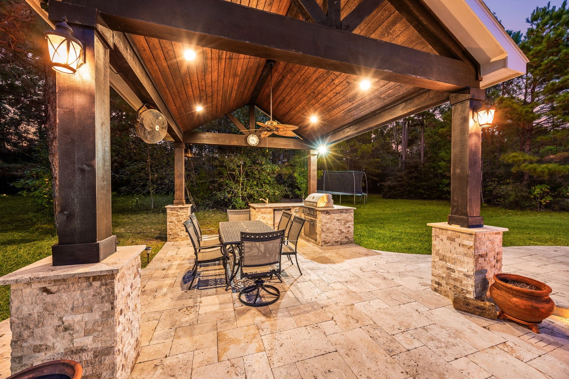 13506 Stagecoach Road, Magnolia, TX 77355 Unwind in your private outdoor retreat featuring a stunning covered pavilion with wood-beamed ceilings, built-in grill, and serene views of the lush backyard.