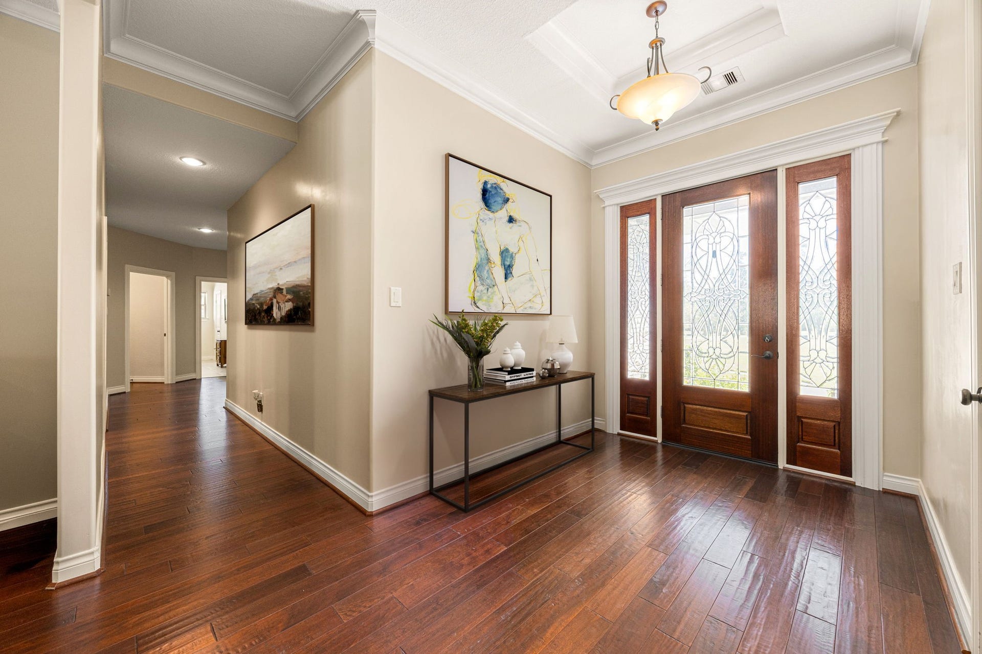 13506 Stagecoach Road, Magnolia, TX 77355 A welcoming entryway with rich wood flooring and elegant double doors sets the tone for this beautiful home, offering a warm first impression and a seamless flow into the main living spaces.