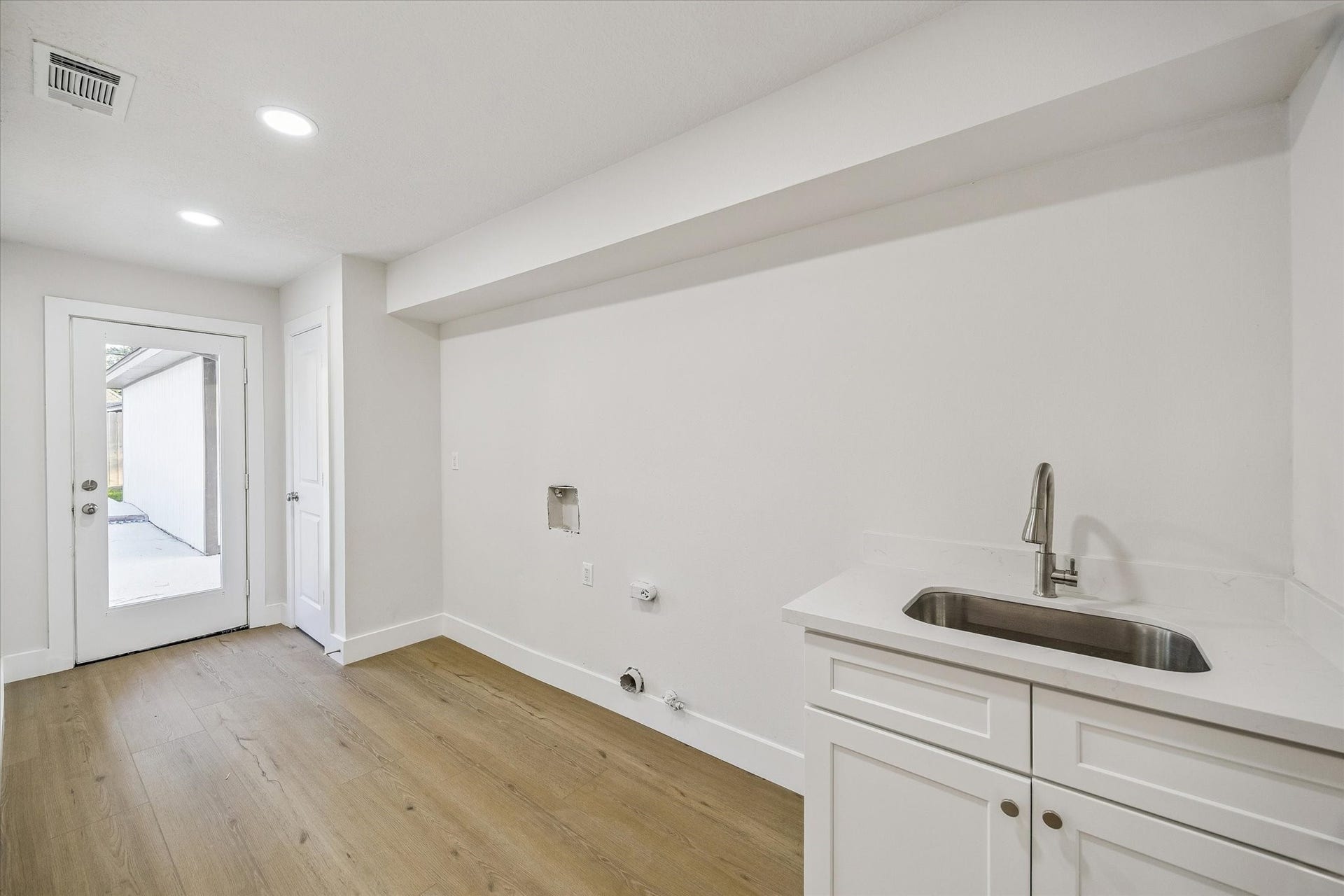 11947 Fawnview Drive, Houston, TX 77070 mudroom & laundrette space with sink.