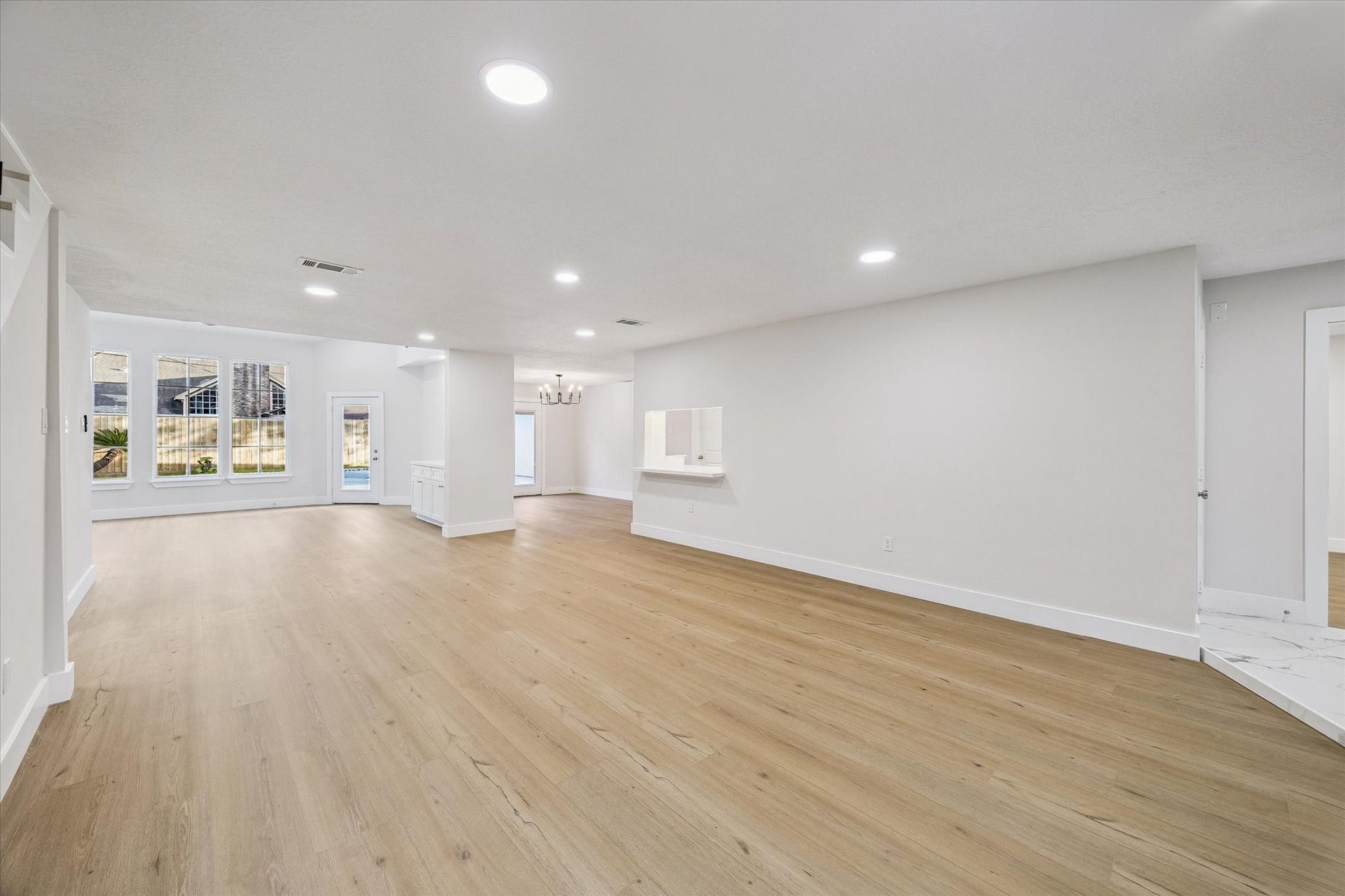 11947 Fawnview Drive, Houston, TX 77070 large open space, formal dining, sun room, fully renovated home throughout. light LVT flooring all throughout the first floor. LED lighting. raised ceilings.