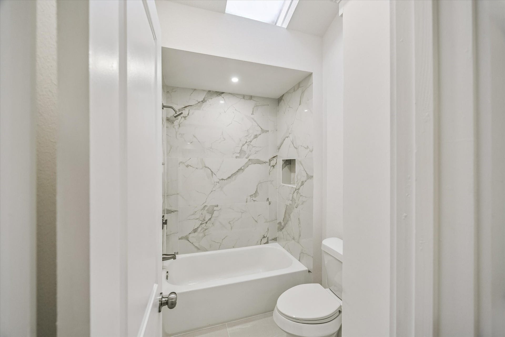 11947 Fawnview Drive, Houston, TX 77070 bathroom finish of shared bathroom between bedroom 2 and 3. sky-light.