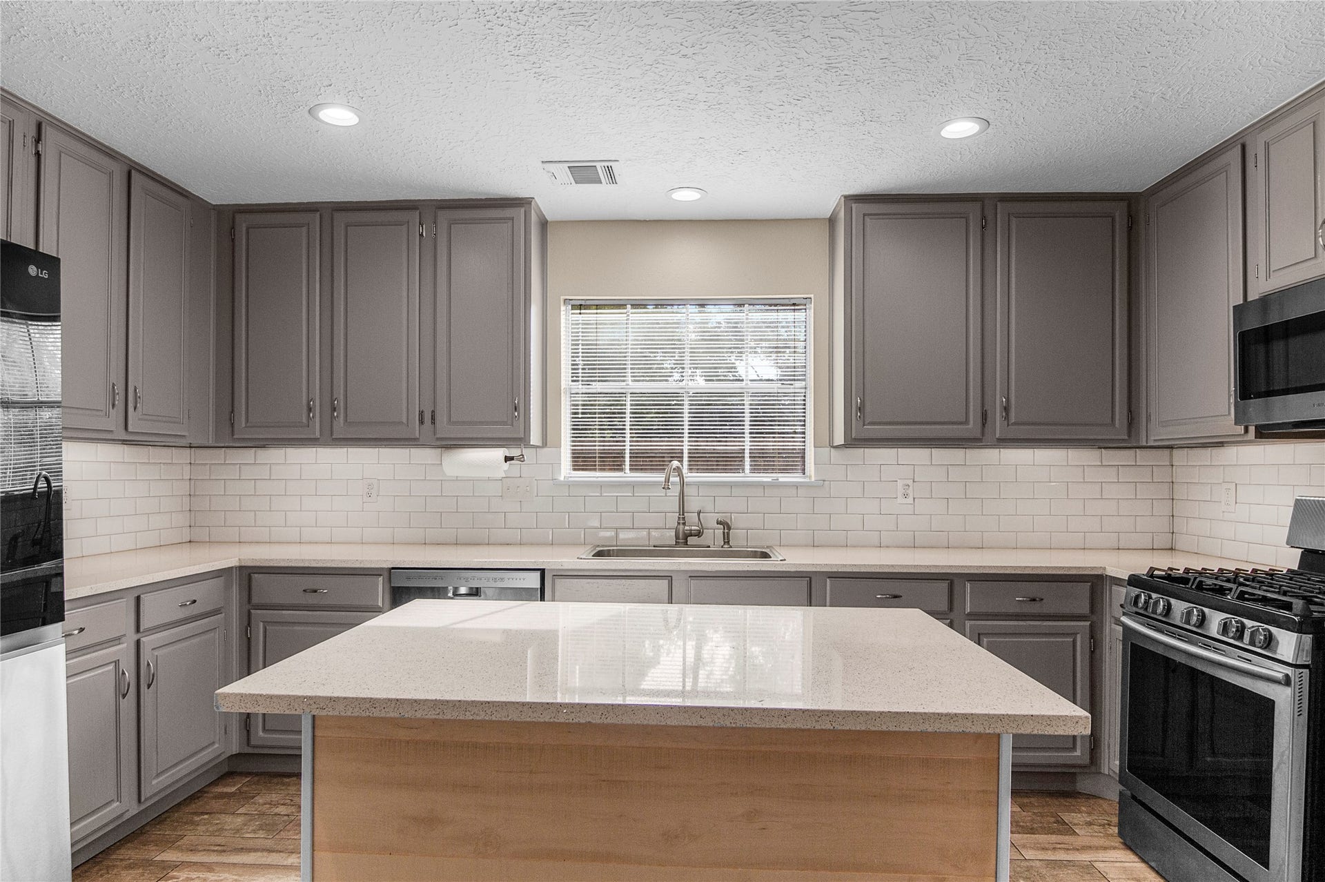 12503 Oakcroft Drive, Houston, TX 77070 a large island with an overhand perfect for bar stools