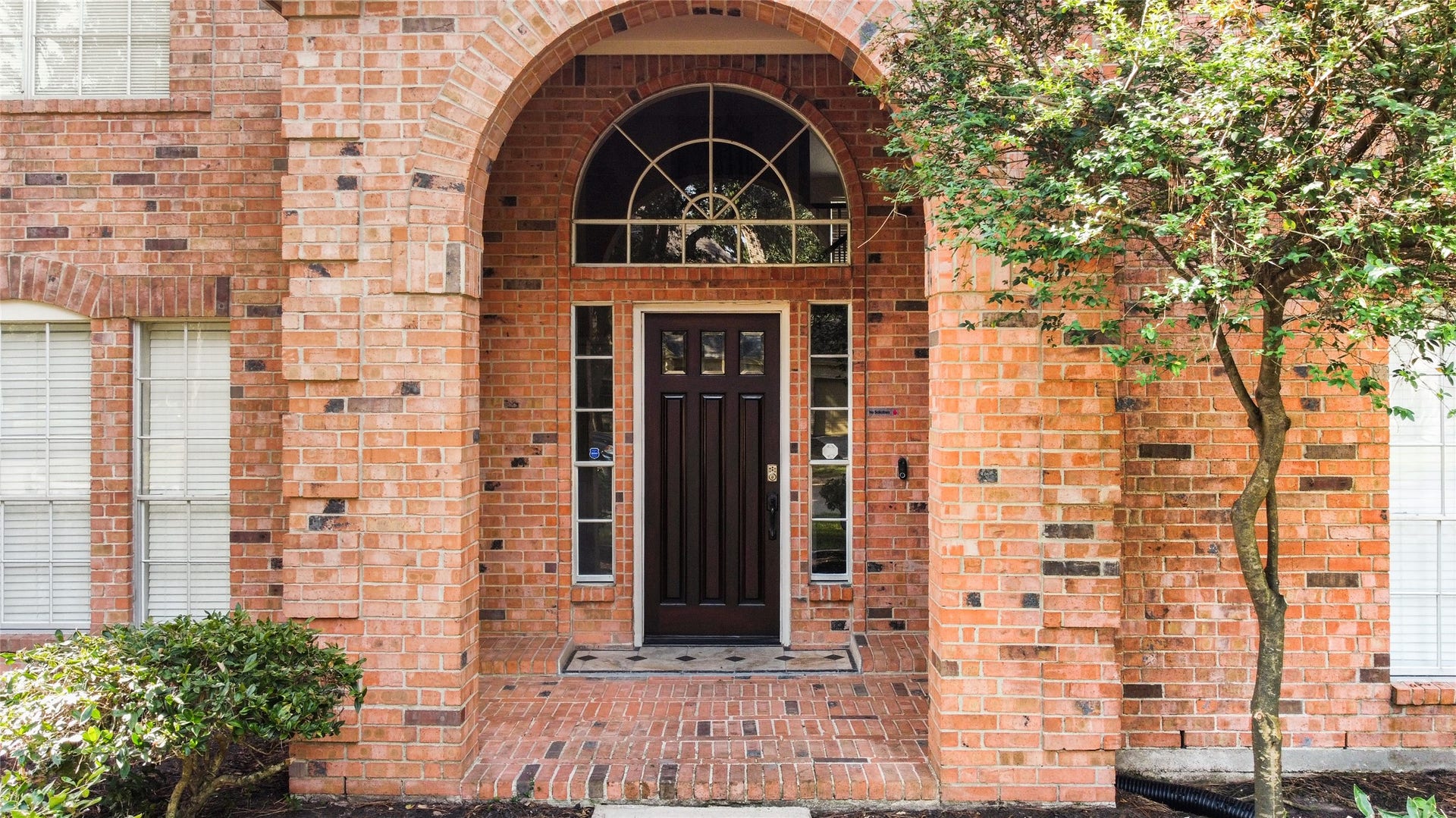 12503 Oakcroft Drive, Houston, TX 77070 Arched masonry and windows with a tiled landing