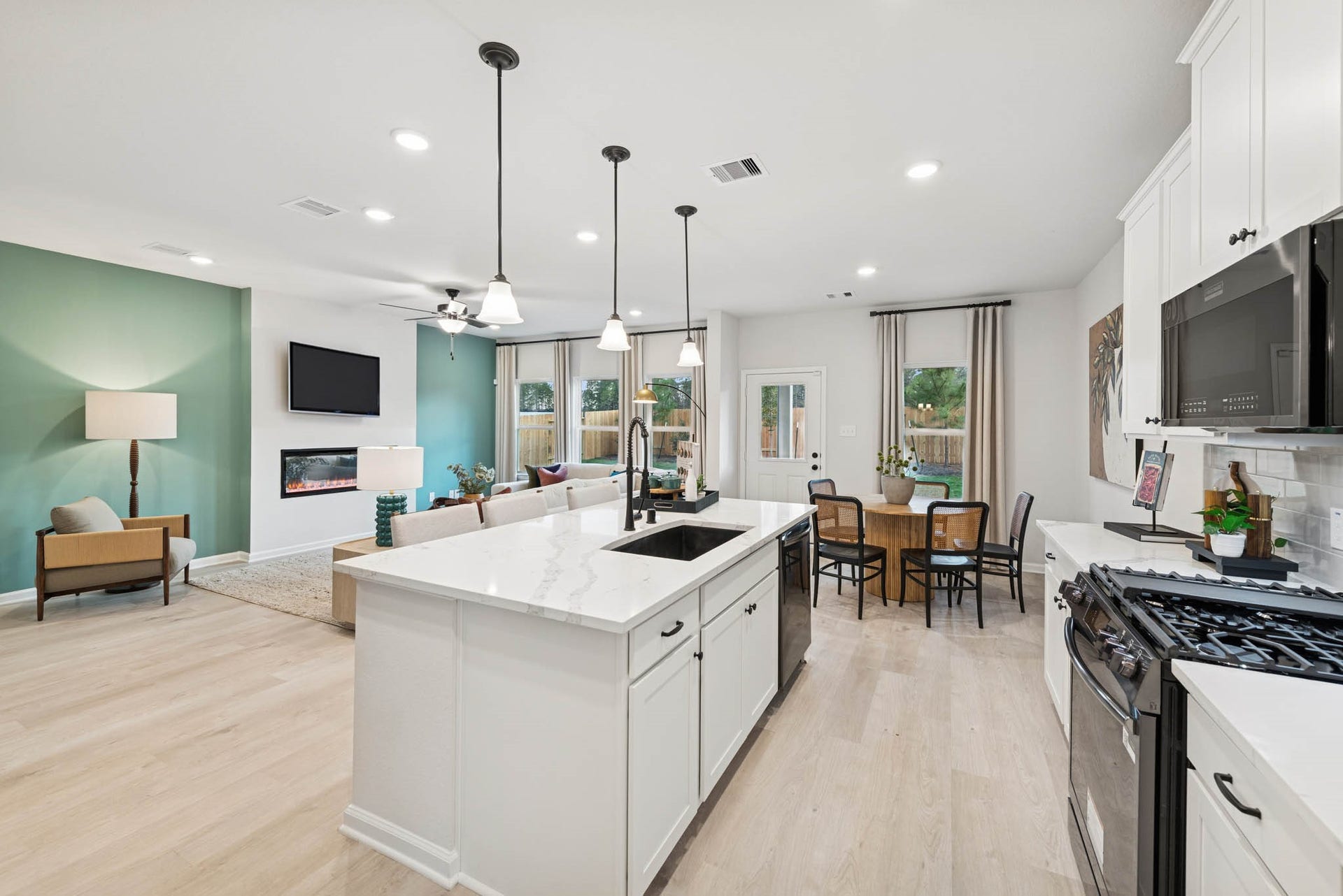 8914 Adana Drive, Montgomery, TX 77316 The Princeton II- Kitchen into the Family Room. Staged model home shown for illustration only; actual features, colors, and upgrades may vary.