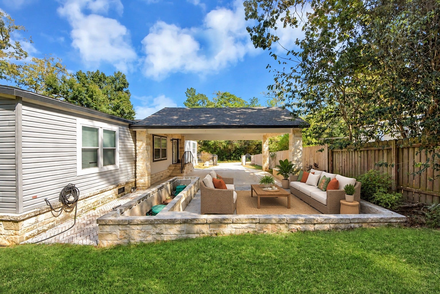 12565 Royal Green Drive, Conroe, TX 77303 Virtually staged open-air paver patio adjacent to the covered carport.