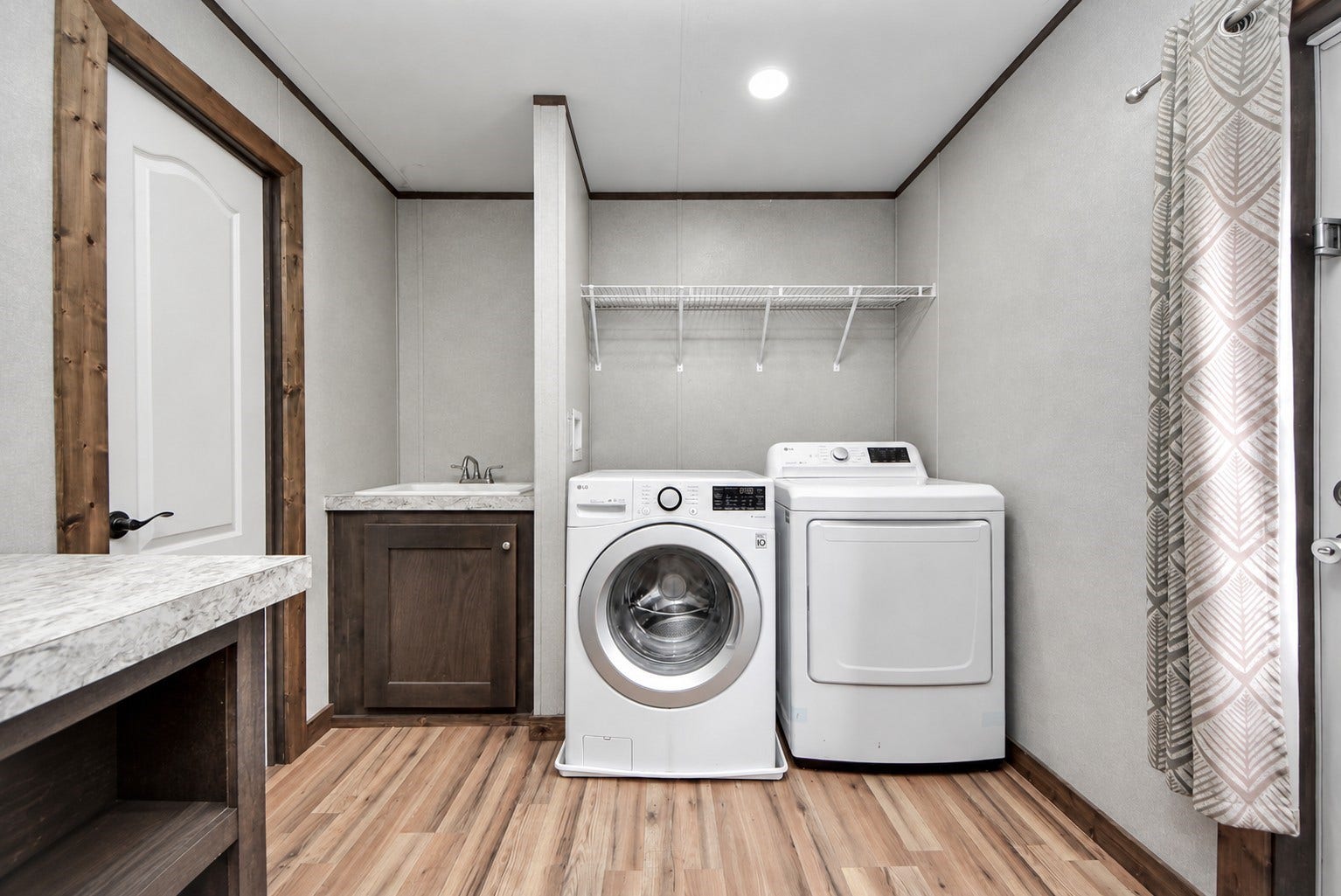 12565 Royal Green Drive, Conroe, TX 77303 Laundry room showcasing a side utility sink and overhead sheliving.