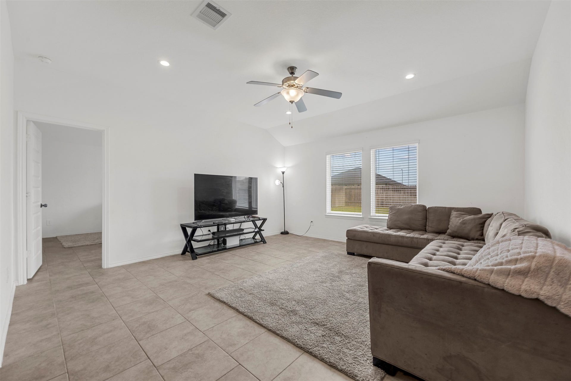 7511 Carson Court, Rosharon, TX 77583 Bright and spacious, this living room offers plenty of room to relax, unwind, and make yourself at home.