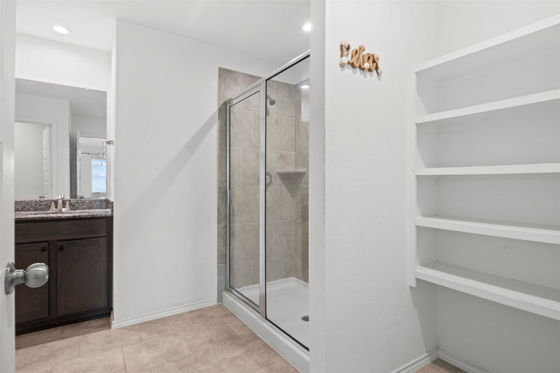 7511 Carson Court, Rosharon, TX 77583 Enjoy a separate walk-in shower and additional bathroom storage for an organized, functional space.