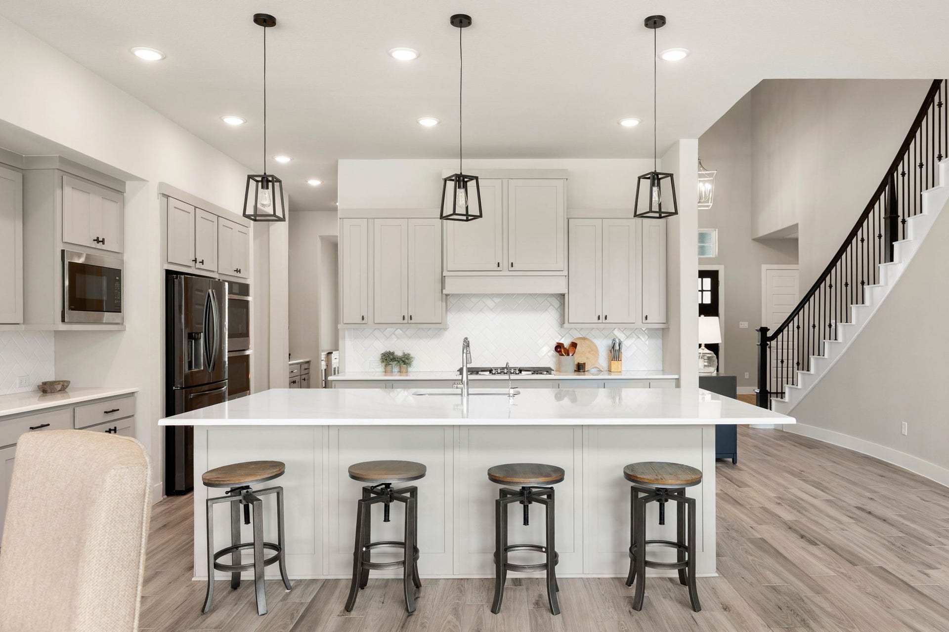 29559 Fulshear Lake Trace, Fulshear, TX 77406 Light and airy kitchen with a large center island, ample storage and an open connection to the breakfast area and family room.