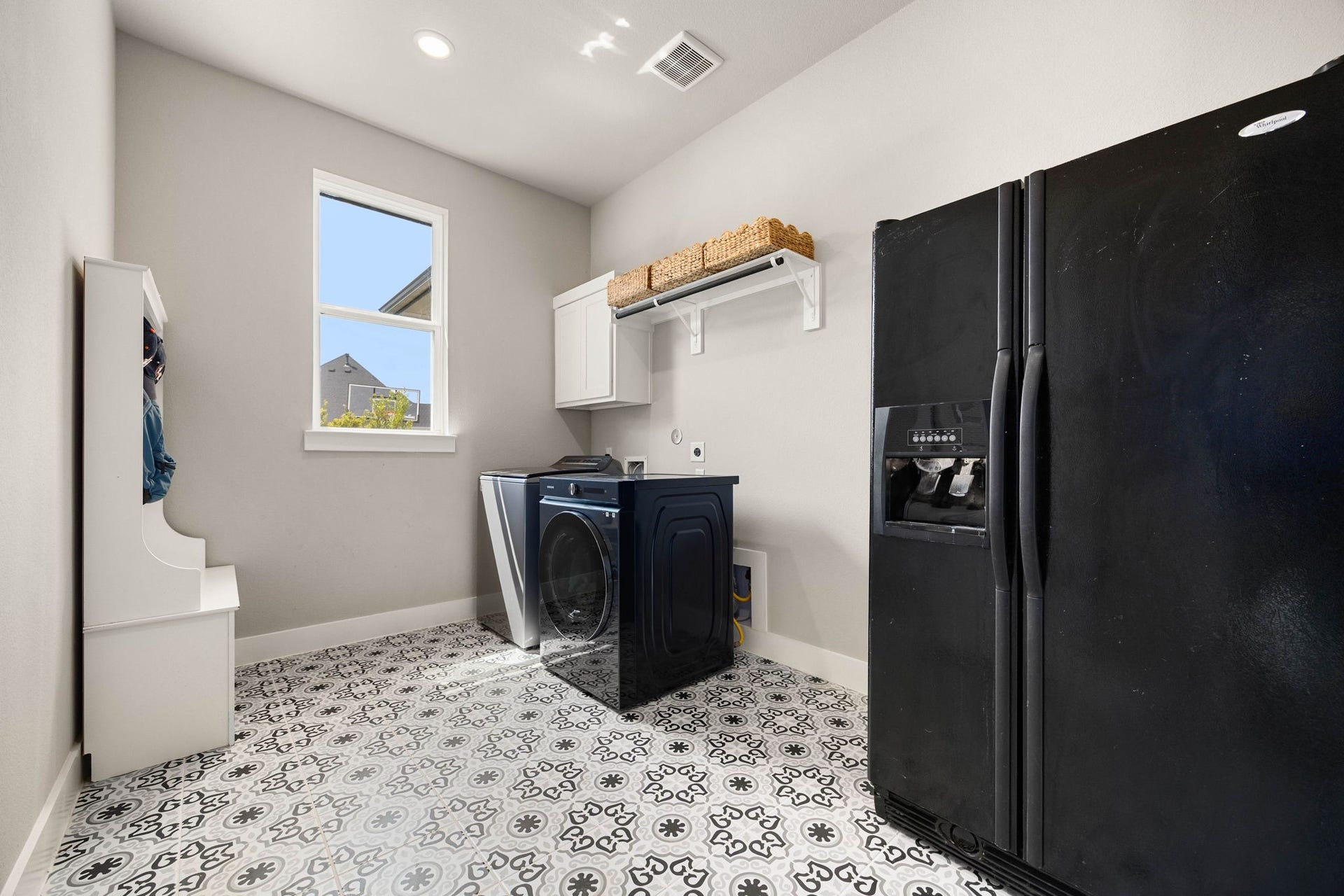 29559 Fulshear Lake Trace, Fulshear, TX 77406 The utility room offers unique tile flooring, upper cabinetry, a storage closet and room for an additional refrigeratorgreat for extra food and beverage storage.