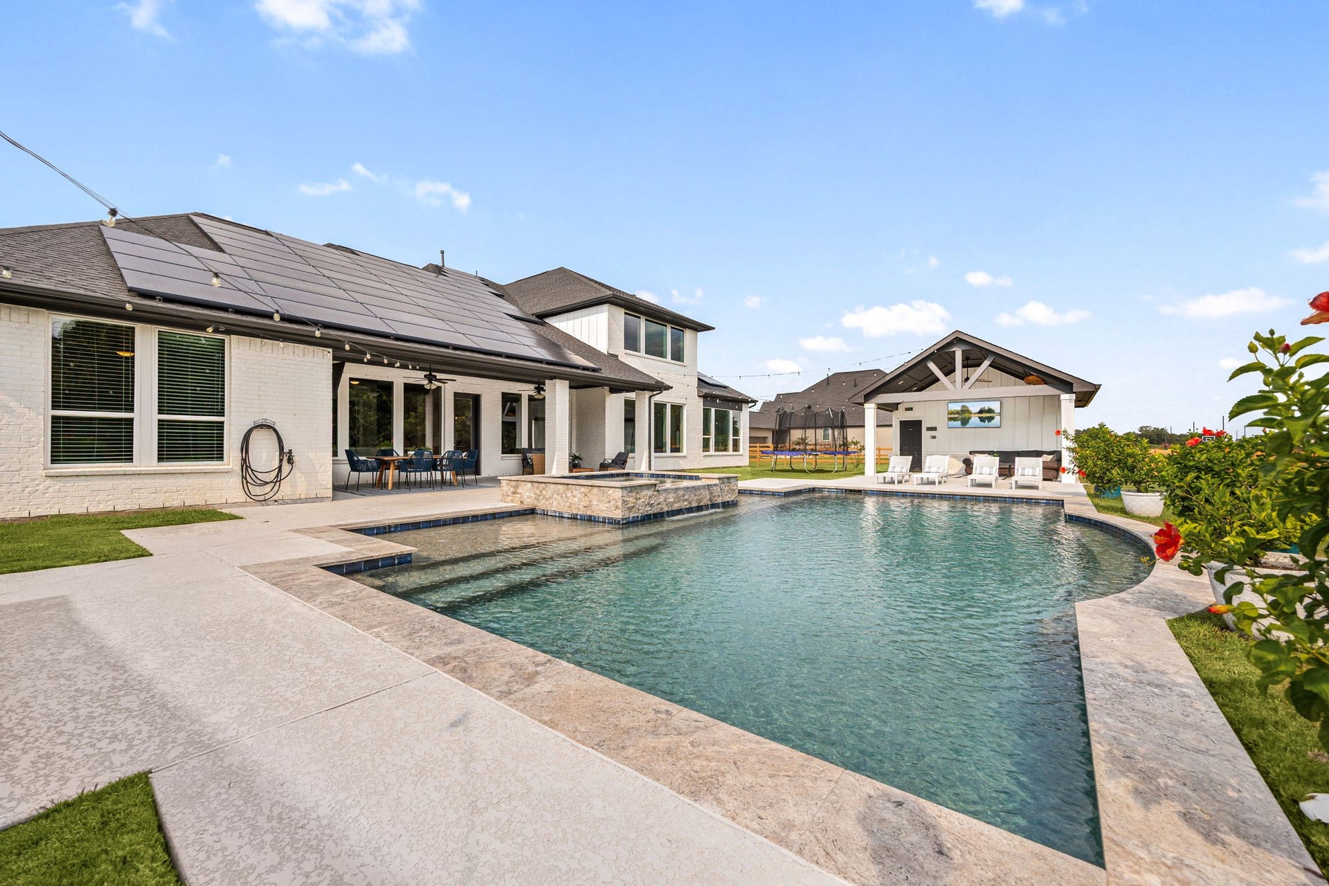 29559 Fulshear Lake Trace, Fulshear, TX 77406 The pool takes center stage with a raised spa and a dedicated cabana just beyond, creating a private backyard retreat designed for relaxing and entertaining.