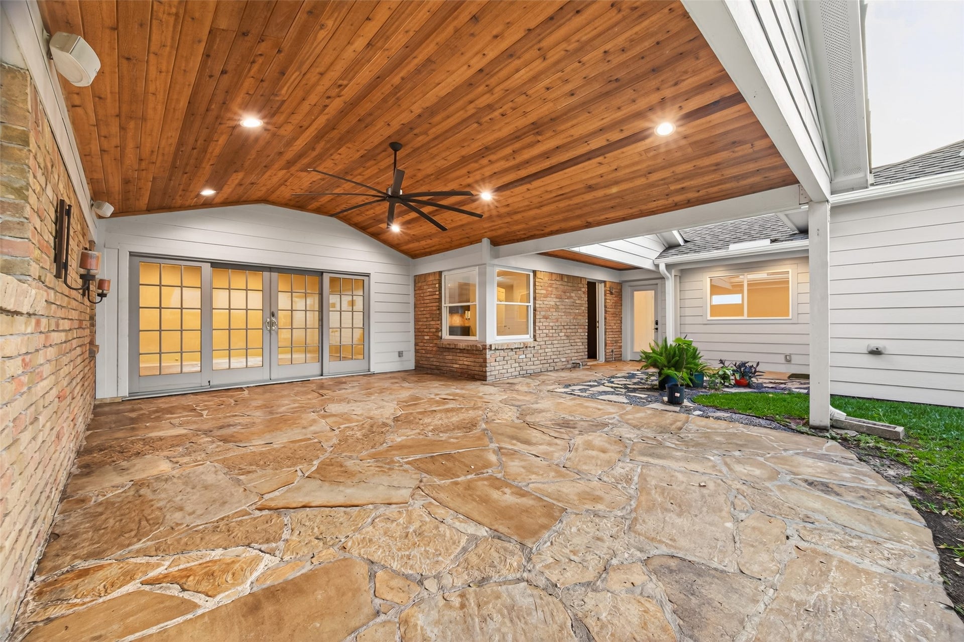 5638 Sanford Road, Houston, TX 77096 Designed for year-round enjoyment, this exceptional outdoor living space features a cedar plank ceiling, flagstone flooring, and a covered breezeway that seamlessly connects the home to the custom-built garage and flex space.