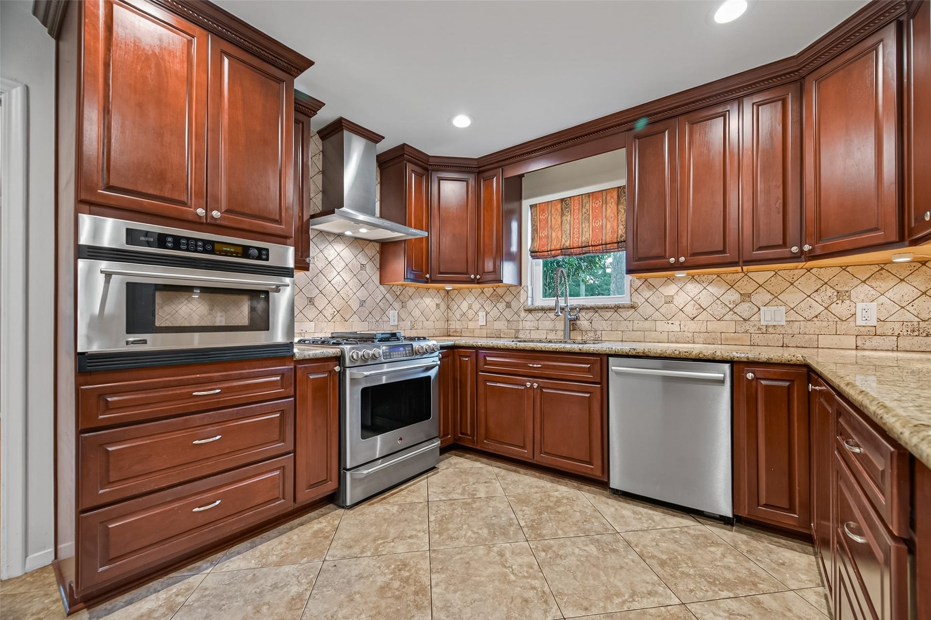 5638 Sanford Road, Houston, TX 77096 Kitchen features a gas range with electric oven and a sink with side yard views.