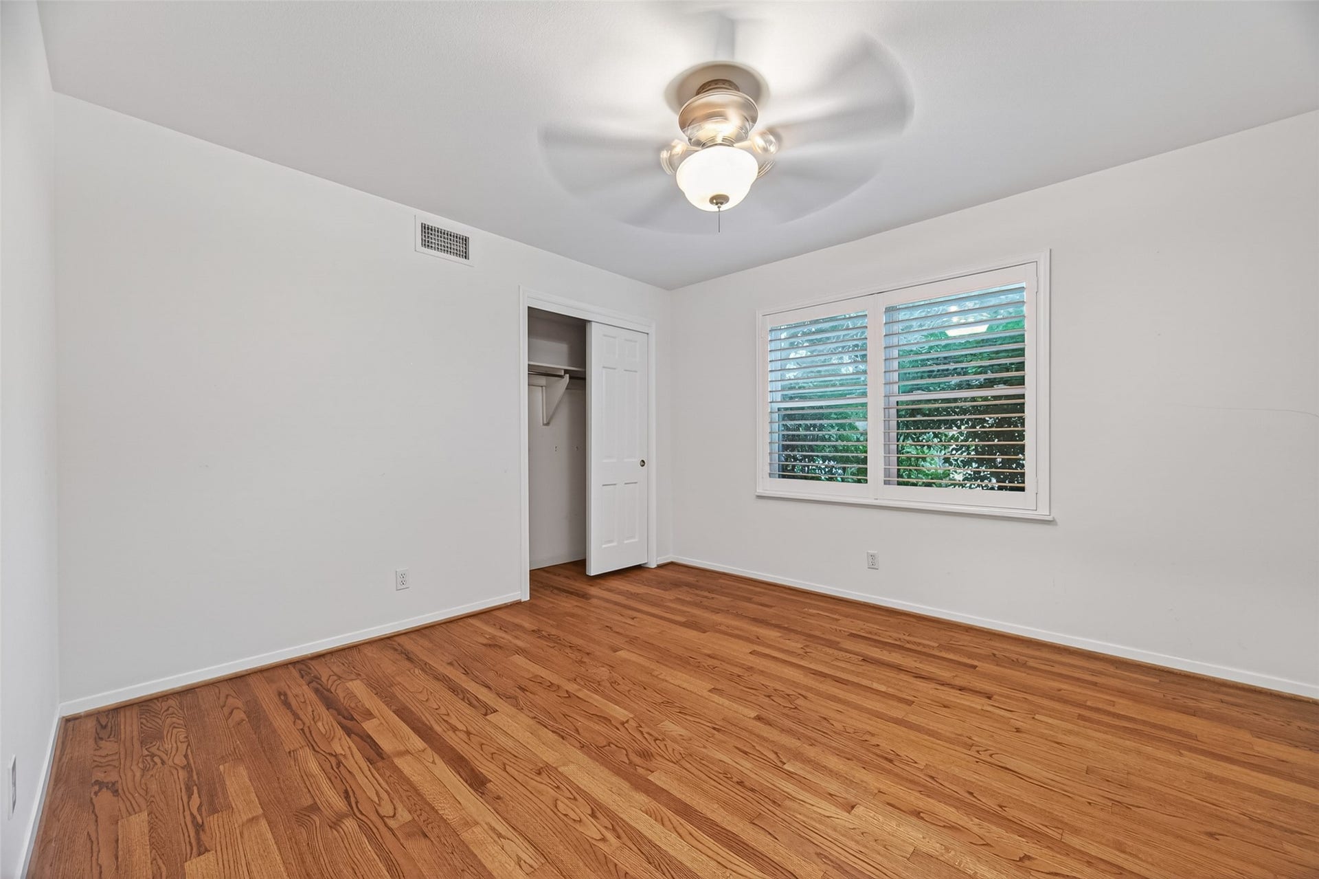 5638 Sanford Road, Houston, TX 77096 Middle secondary bedroom featuring a large window for natural light and a generously sized closet for ample storage.